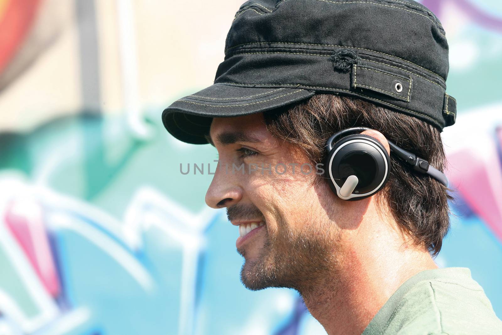 happy casual guy listening to player in earphones