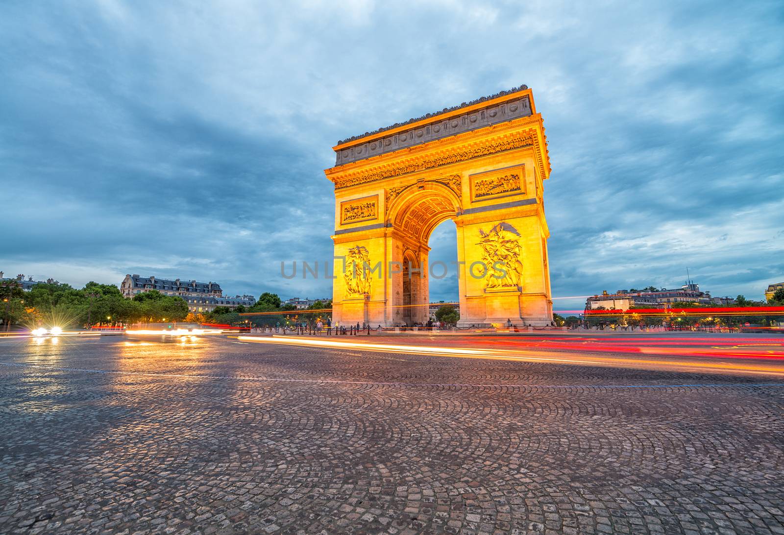 Triumph Arc with city traffic at night, Paris.