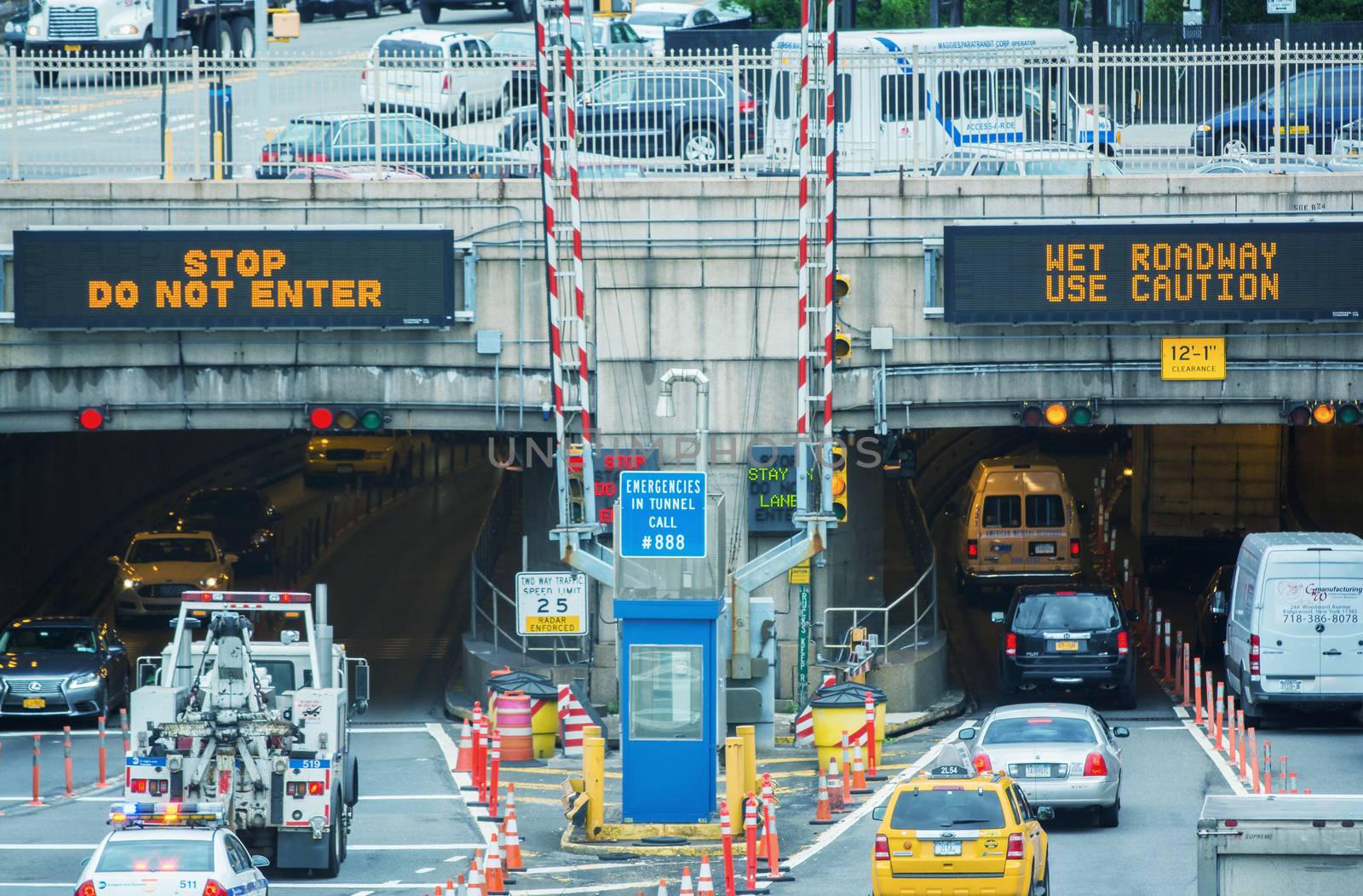 NEW YORK CITY - MAY 10, 2014: Entrance of Queens Midtown Tunnel with city traffic. Designed by Ole Singstad, it was opened to traffic on November 15, 1940.