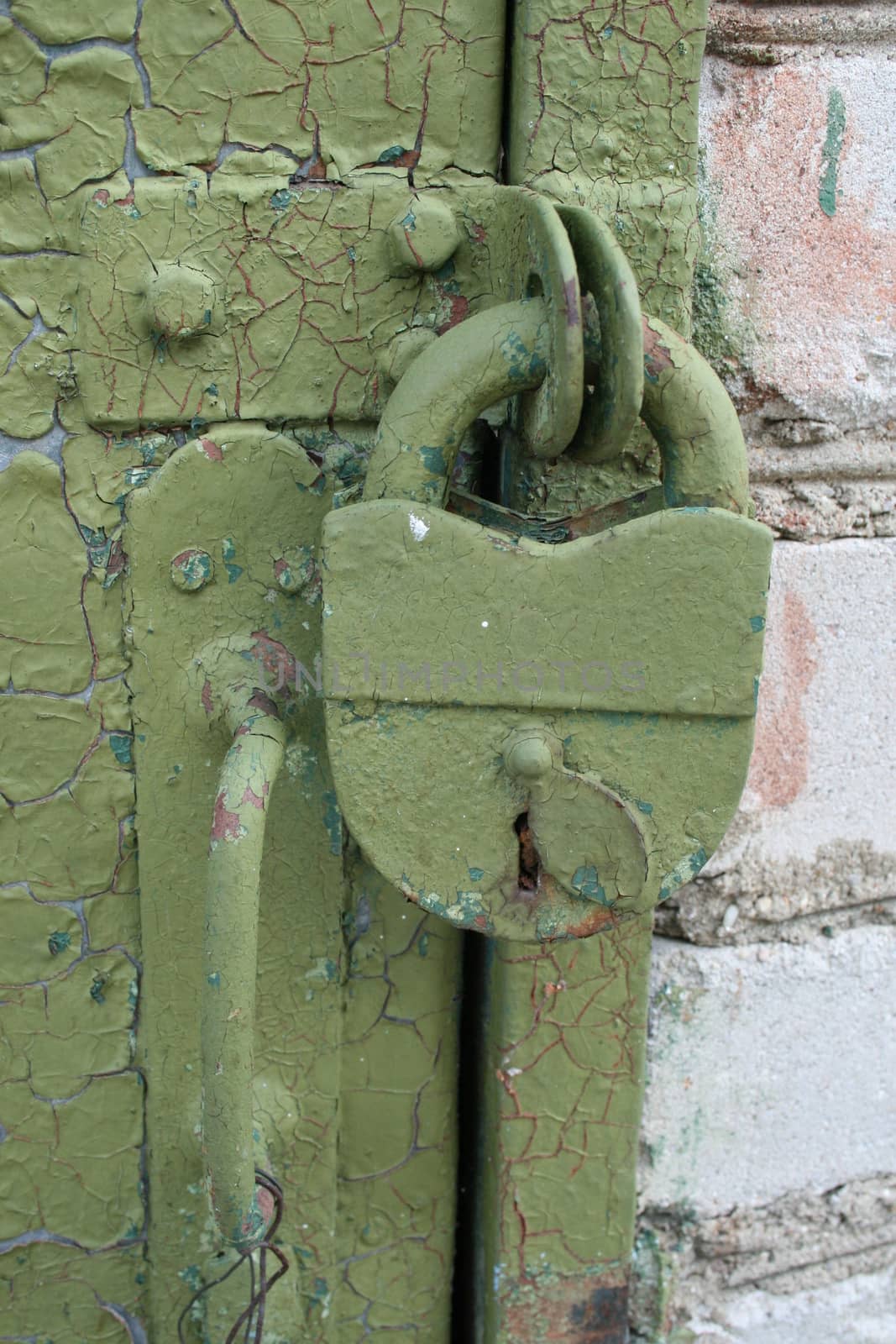 Old iron lock on the door. Castle green painted
