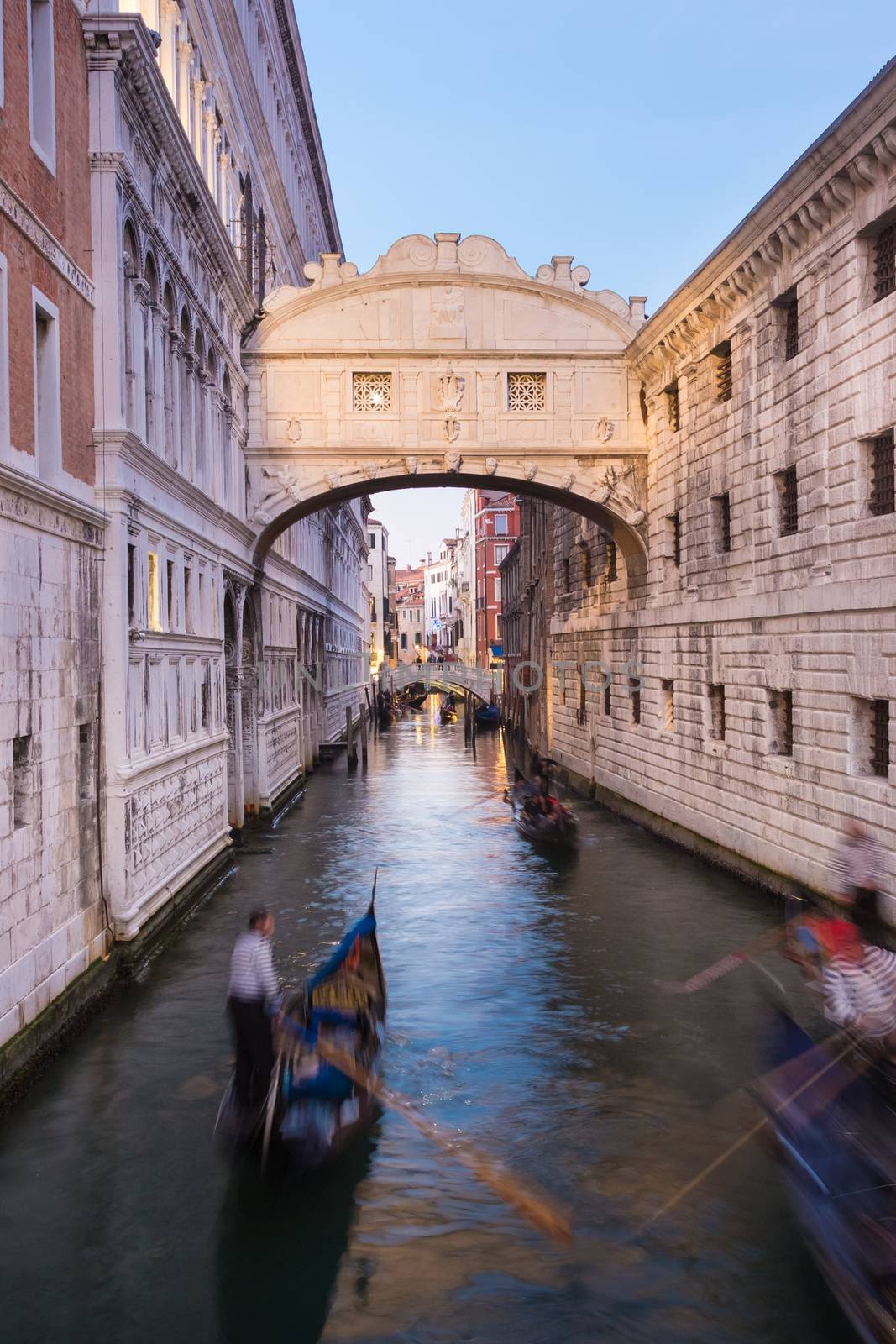 Gondolas passing under Bridge of Sighs, Ponte dei Sospiri. A legend says that lovers will be granted eternal love if they kiss on a gondola at sunset under the Bridge. Venice,Veneto, Italy, Europe. 