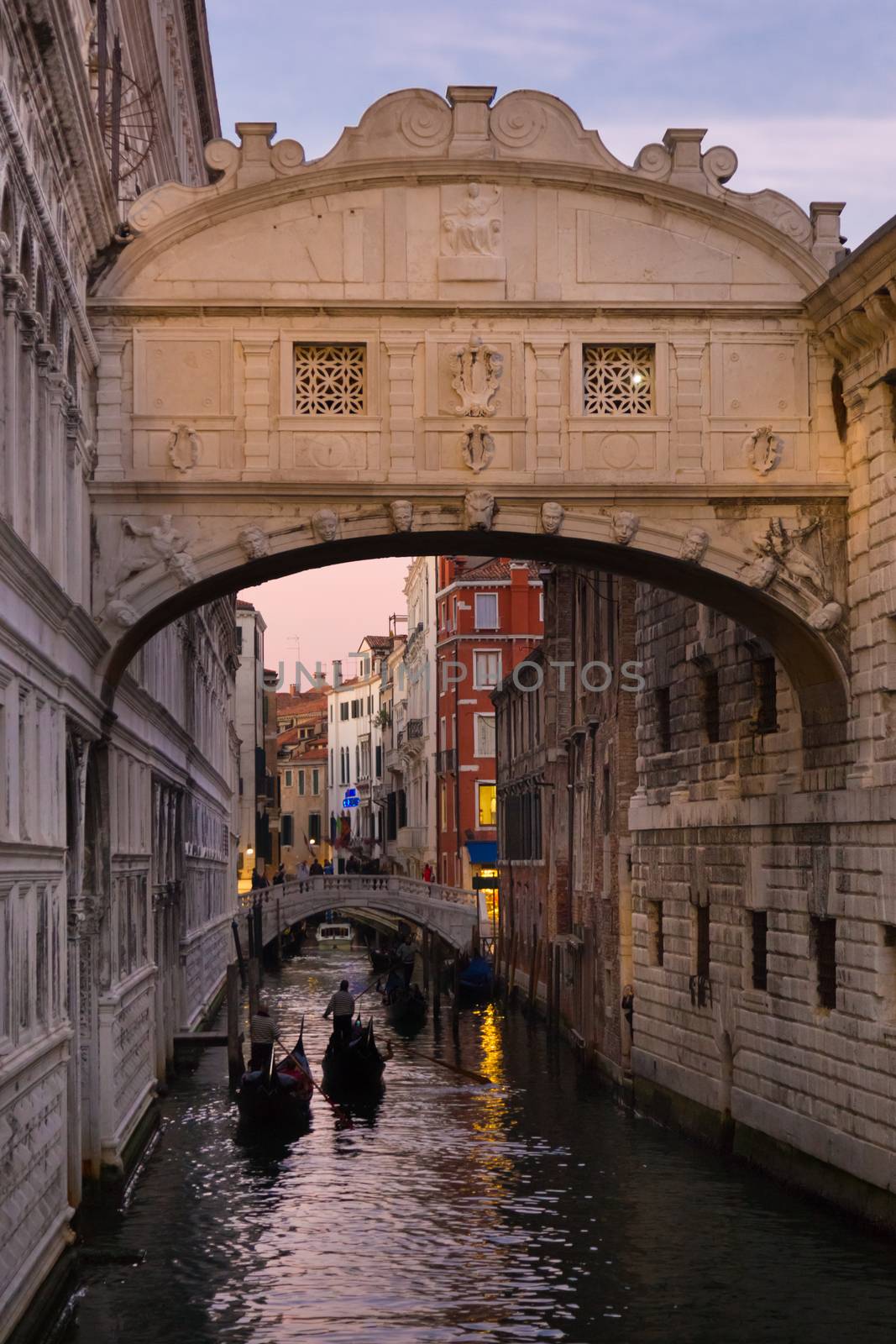 Gondolas passing under Bridge of Sighs, Ponte dei Sospiri. A legend says that lovers will be granted eternal love if they kiss on a gondola at sunset under the Bridge. Venice,Veneto, Italy, Europe. 