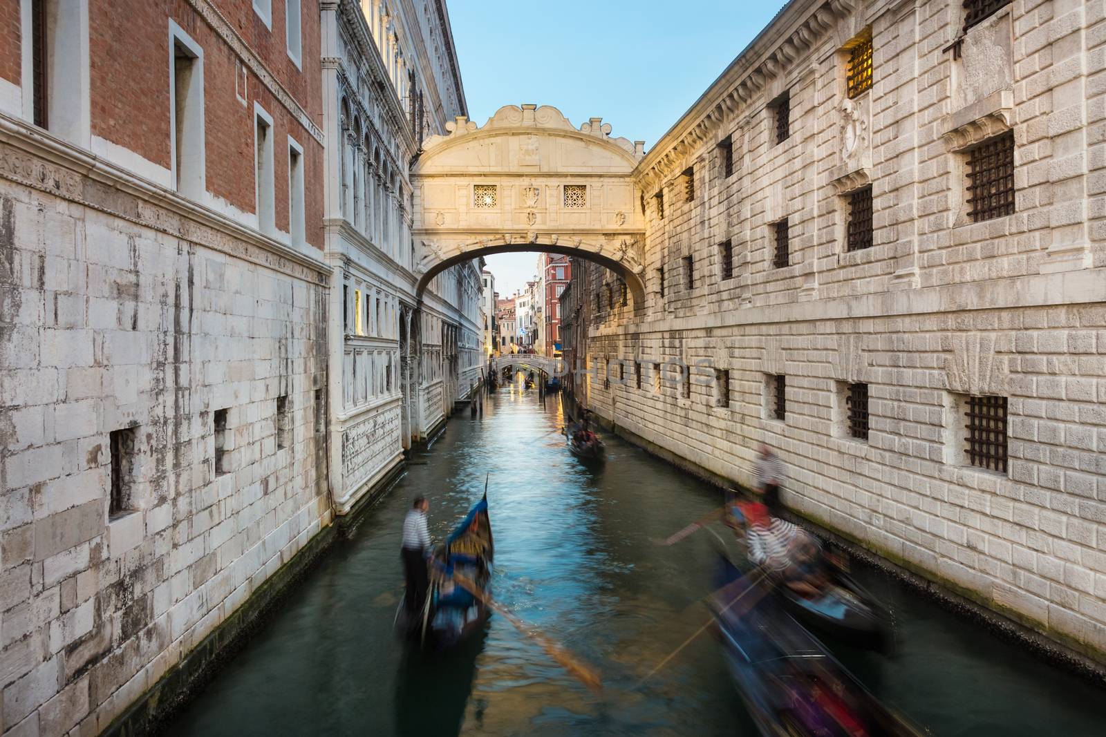 Gondolas passing under Bridge of Sighs, Ponte dei Sospiri. A legend says that lovers will be granted eternal love if they kiss on a gondola at sunset under the Bridge. Venice,Veneto, Italy, Europe. 