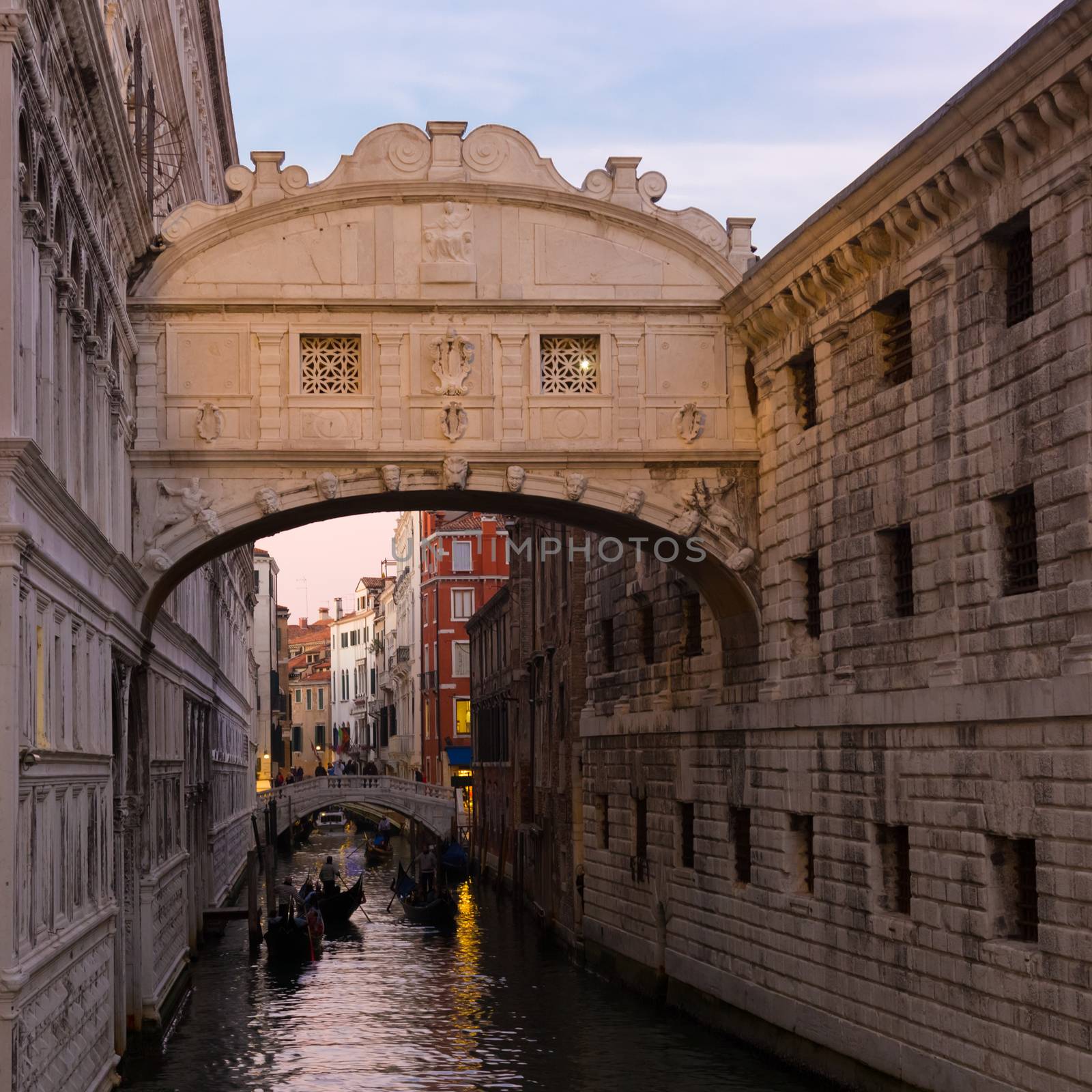 Gondolas passing under Bridge of Sighs, Ponte dei Sospiri. A legend says that lovers will be granted eternal love if they kiss on a gondola at sunset under the Bridge. Venice,Veneto, Italy, Europe. 