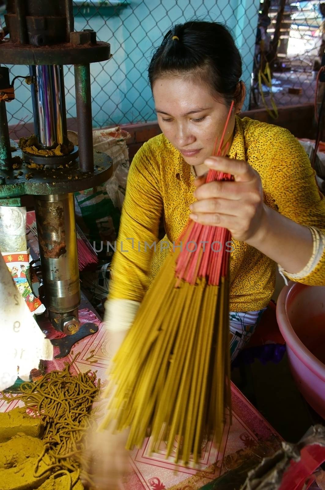 MEKONG DELTA, VIETNAM- JULY 7: Woman working incense shop, people product  insense stick as handicraft for religion life, this traditional trade is popular at mekong delta, Viet Nam, July 7, 2014