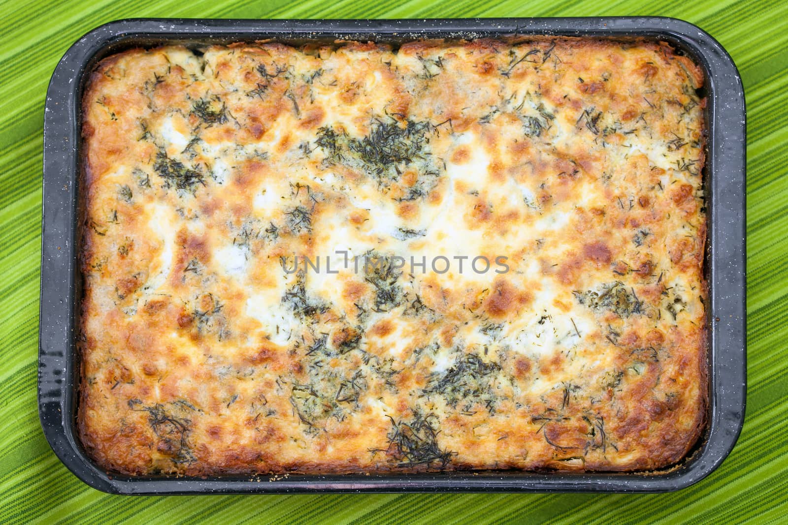 Cauliflower baked with eggs, cheese and parsley on top