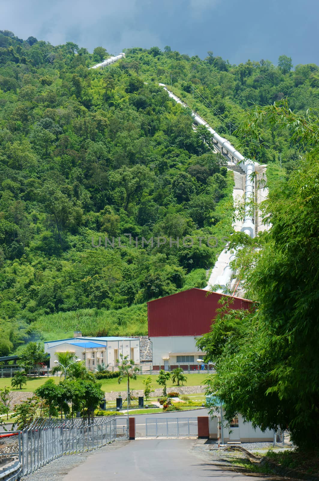 Dai Ninh hydroelectric power plant at Vietnam countryside, plant with water pipe system cross green mountain, up to sky, Vietnam has many hydroelectric power station