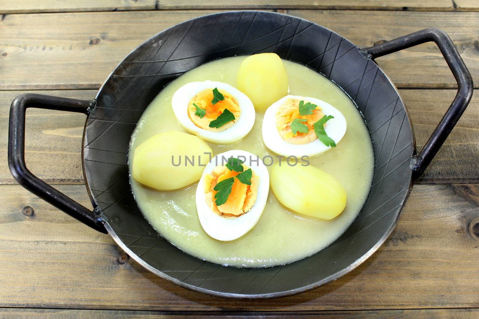 a pan with mustard eggs and potatoes