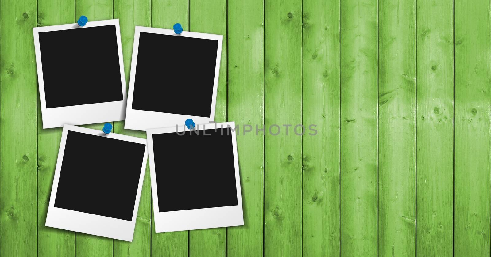 Four blank photo frames with push pin, shadow and empty space for your photograph, picture and copy on green wooden grunge background.