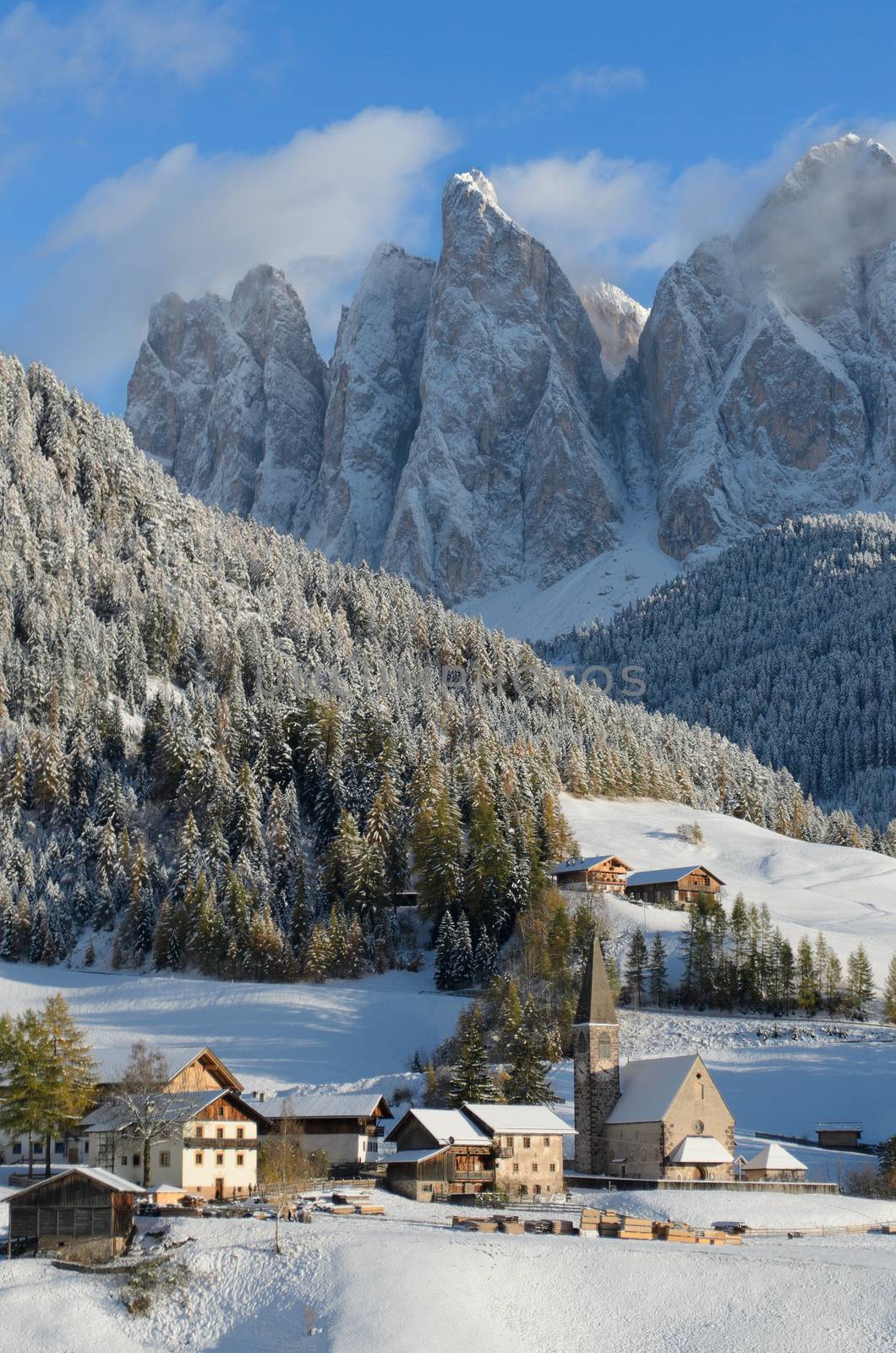 The church of St. Magdalena or Santa Maddalena, a village in front of the Geisler or Odle dolomites mountain peaks in the Val di Funes (Villnösser Tal) in South Tyrol in Italy in winter.