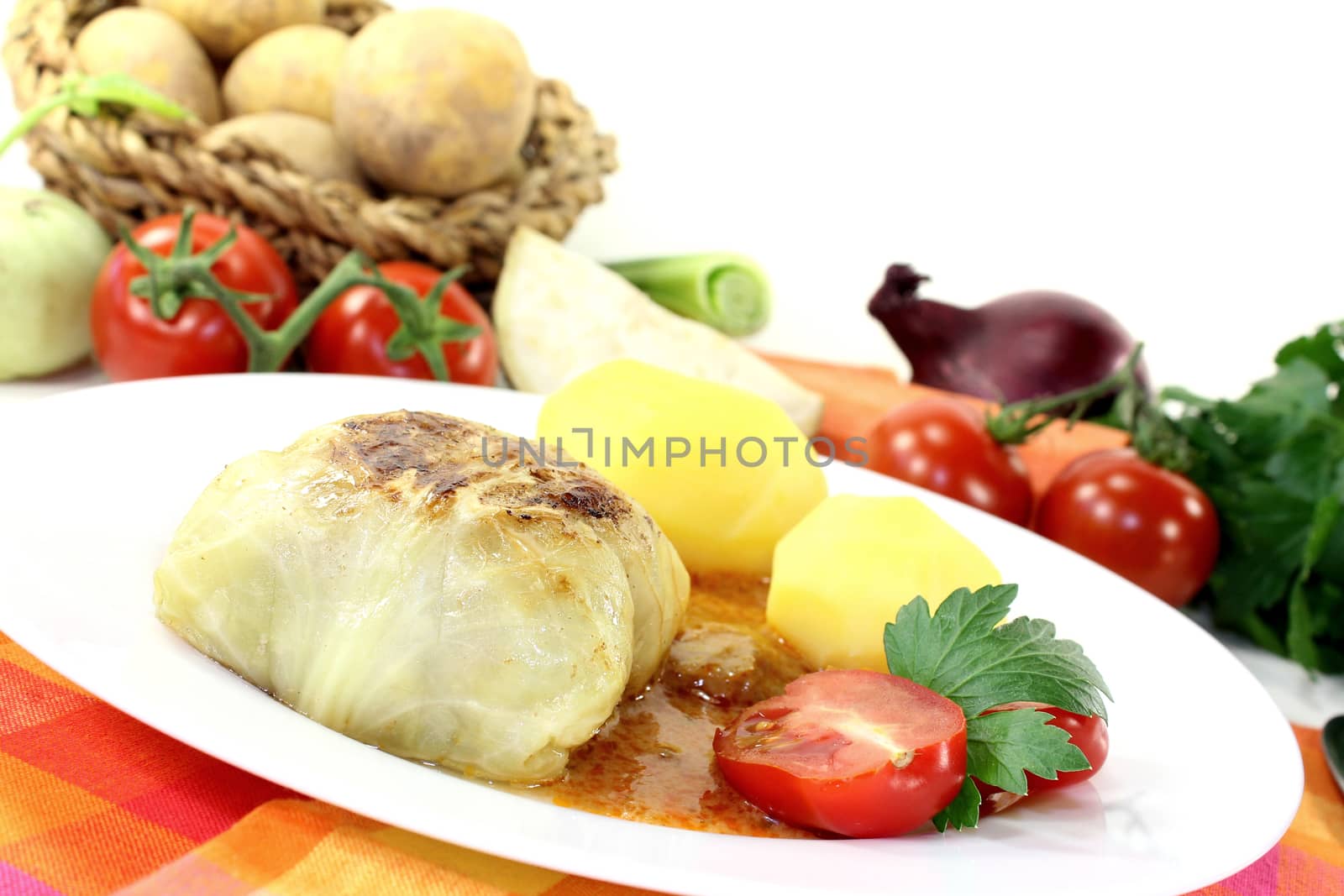 Stuffed cabbage with potatoes on bright background