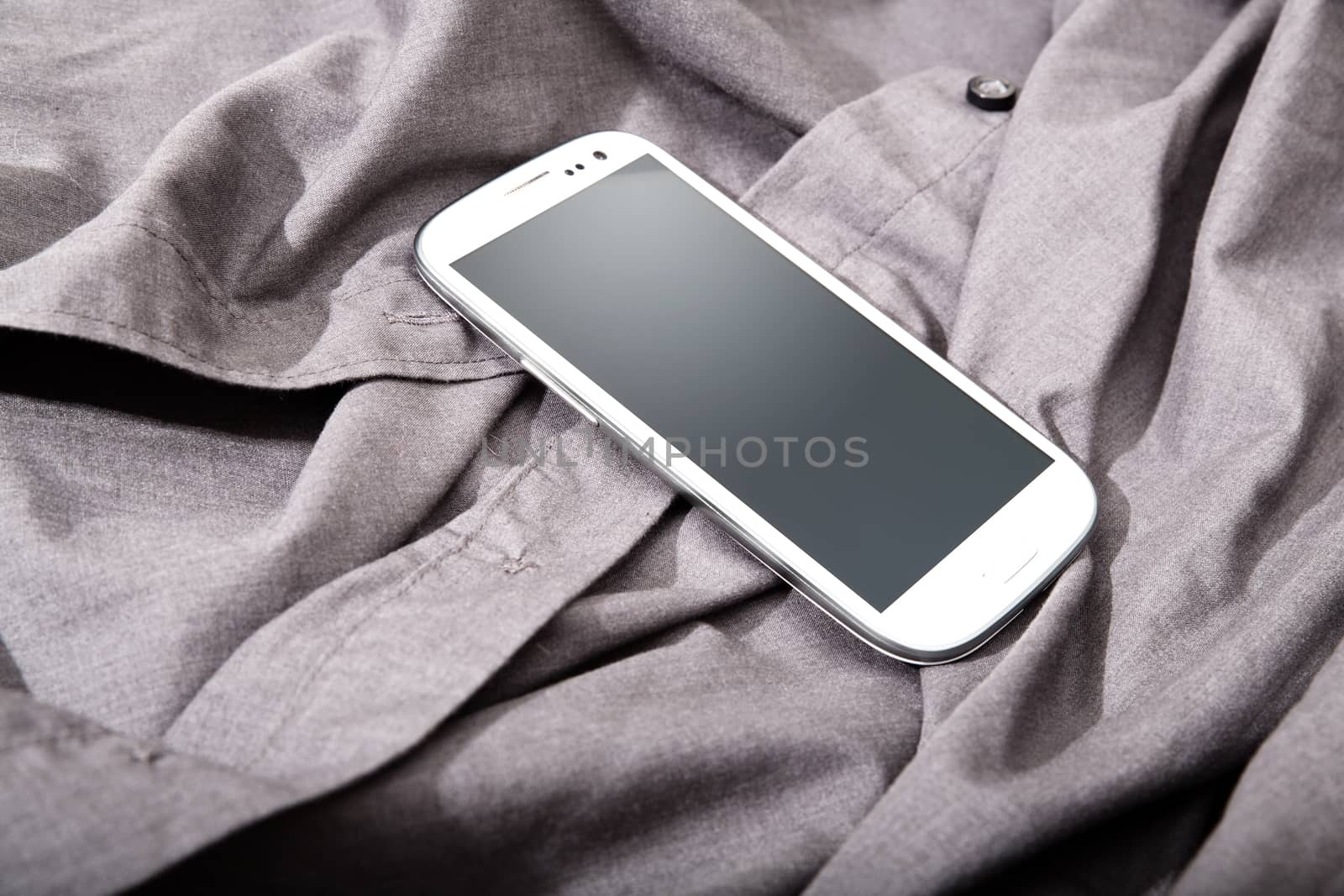 A Smartphone on some dark cloth.