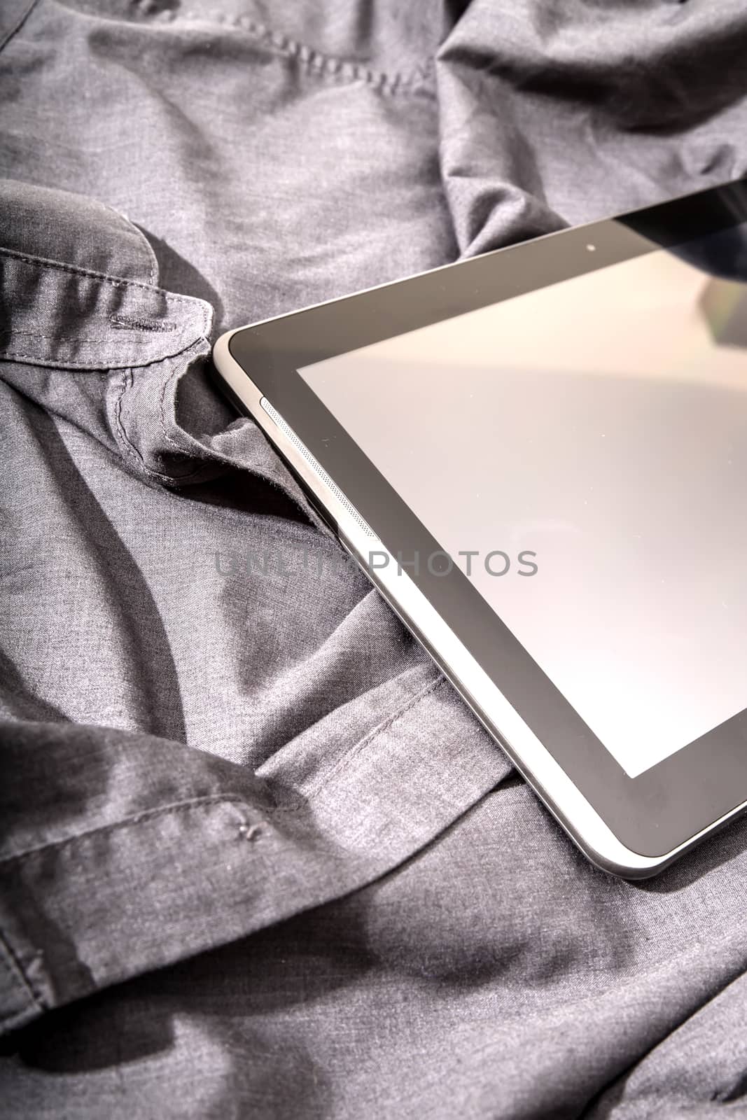 A Tablet PC on some dark cloth.