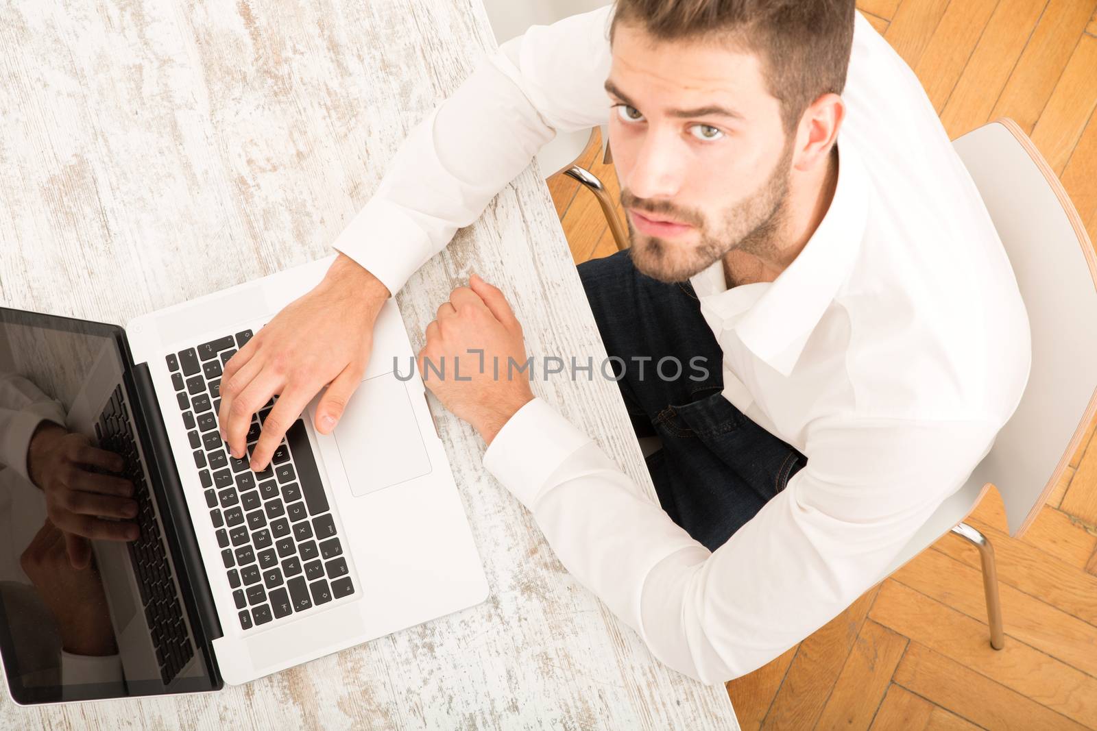 Young man with a laptop computer	 by Spectral