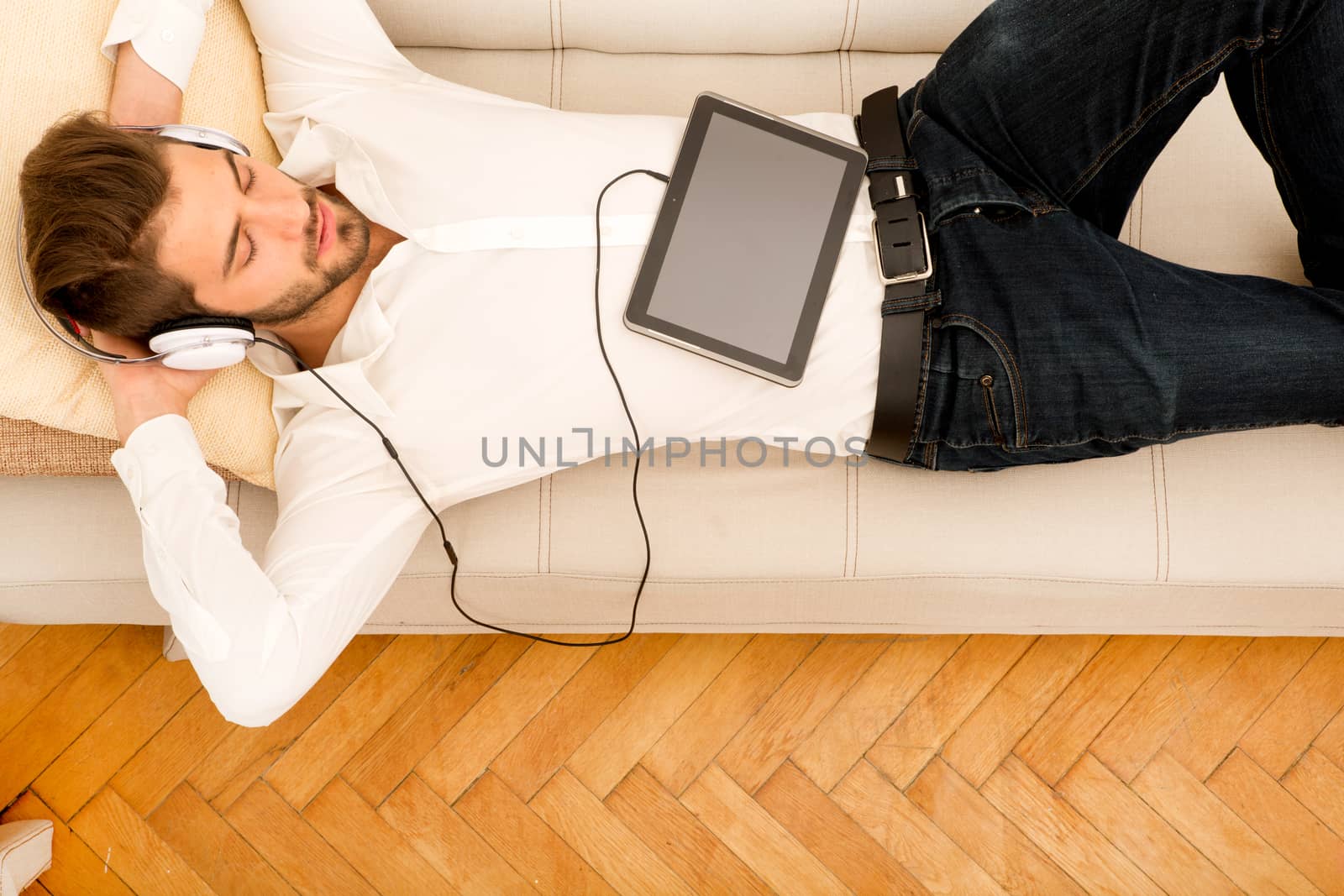 Young man listening to music	 by Spectral