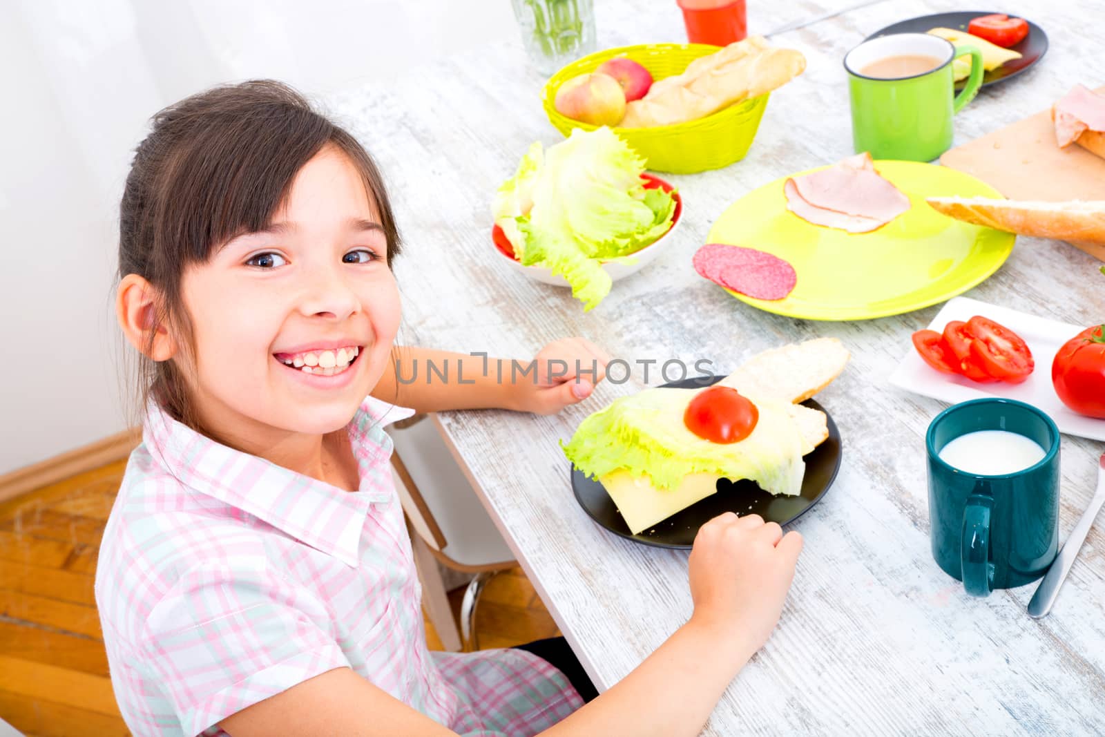 A little girl having breakfast at home.
