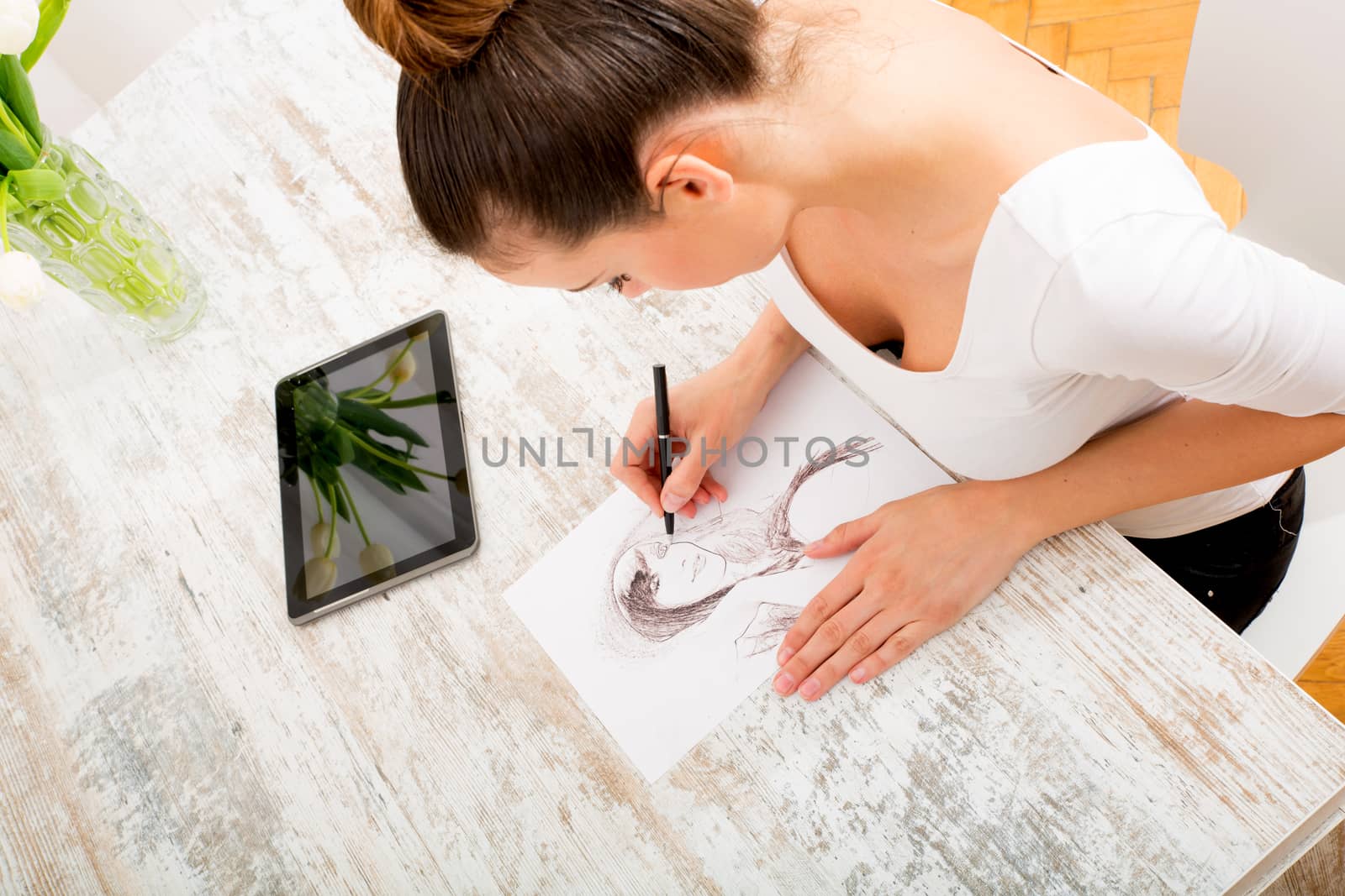 A young fashion designer working with a tablet pc.
