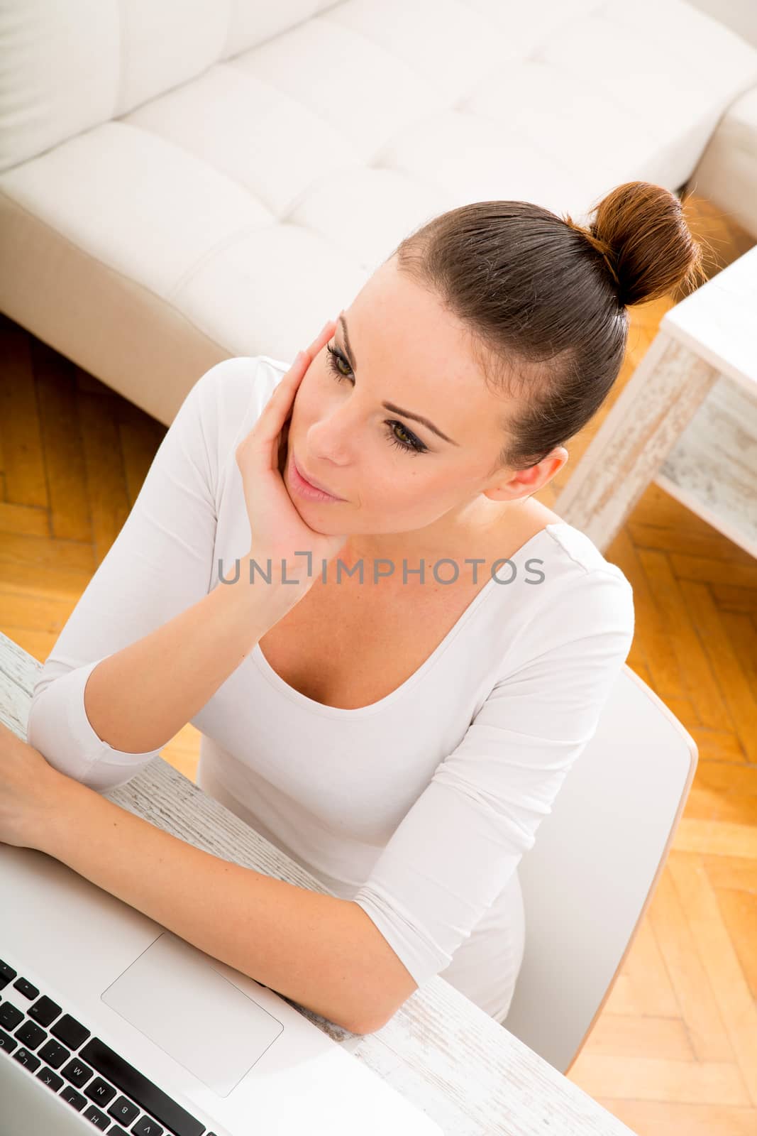 Portrait of a young adult woman with laptop.
