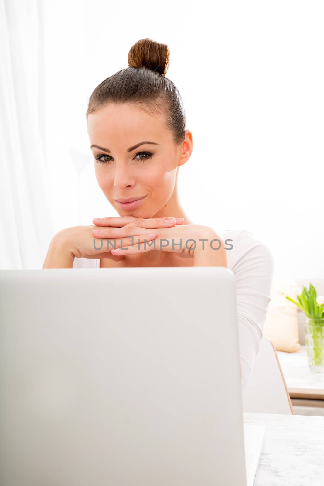 Portrait of a young adult woman with laptop.
