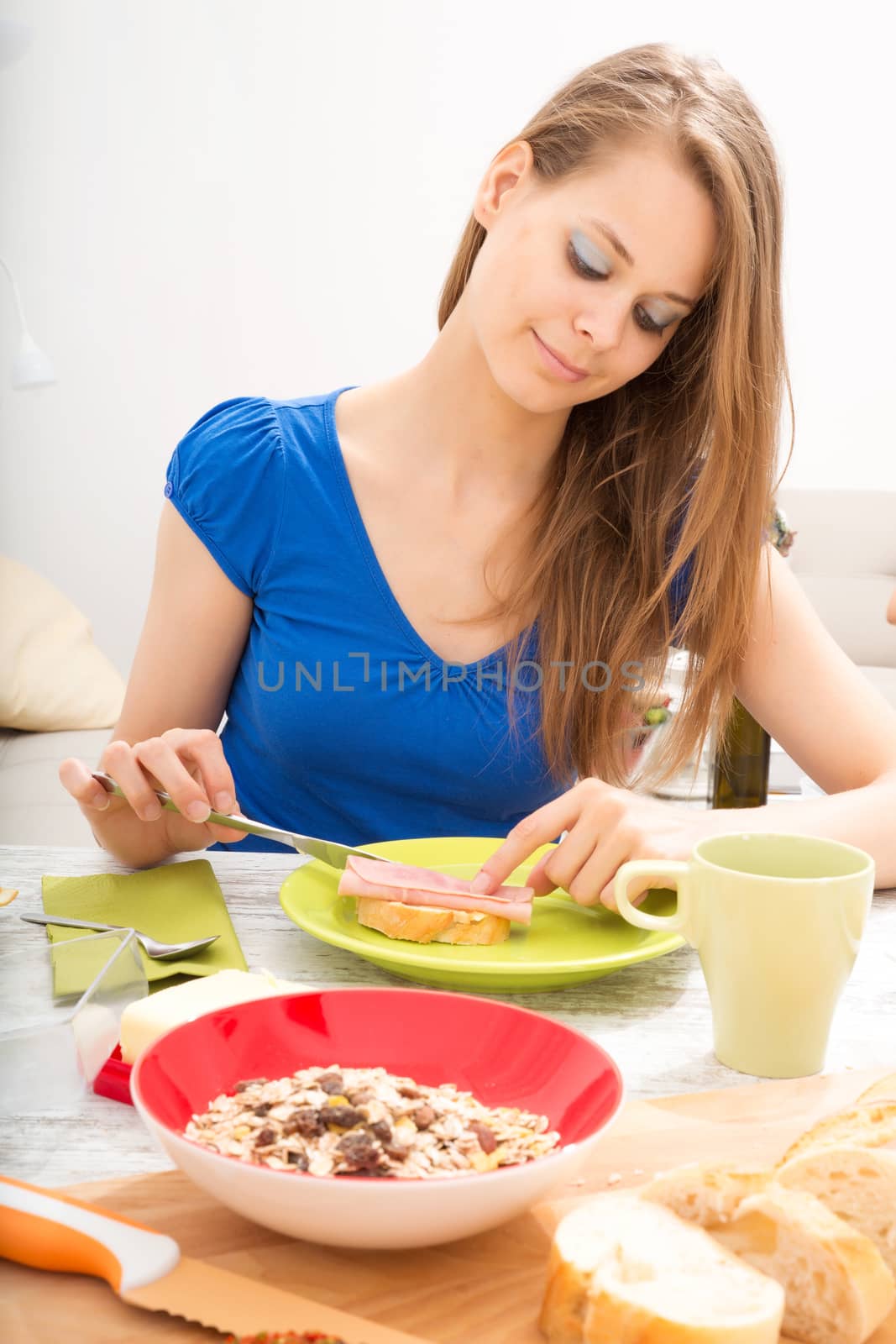 Young woman preparing a european breakfast by Spectral
