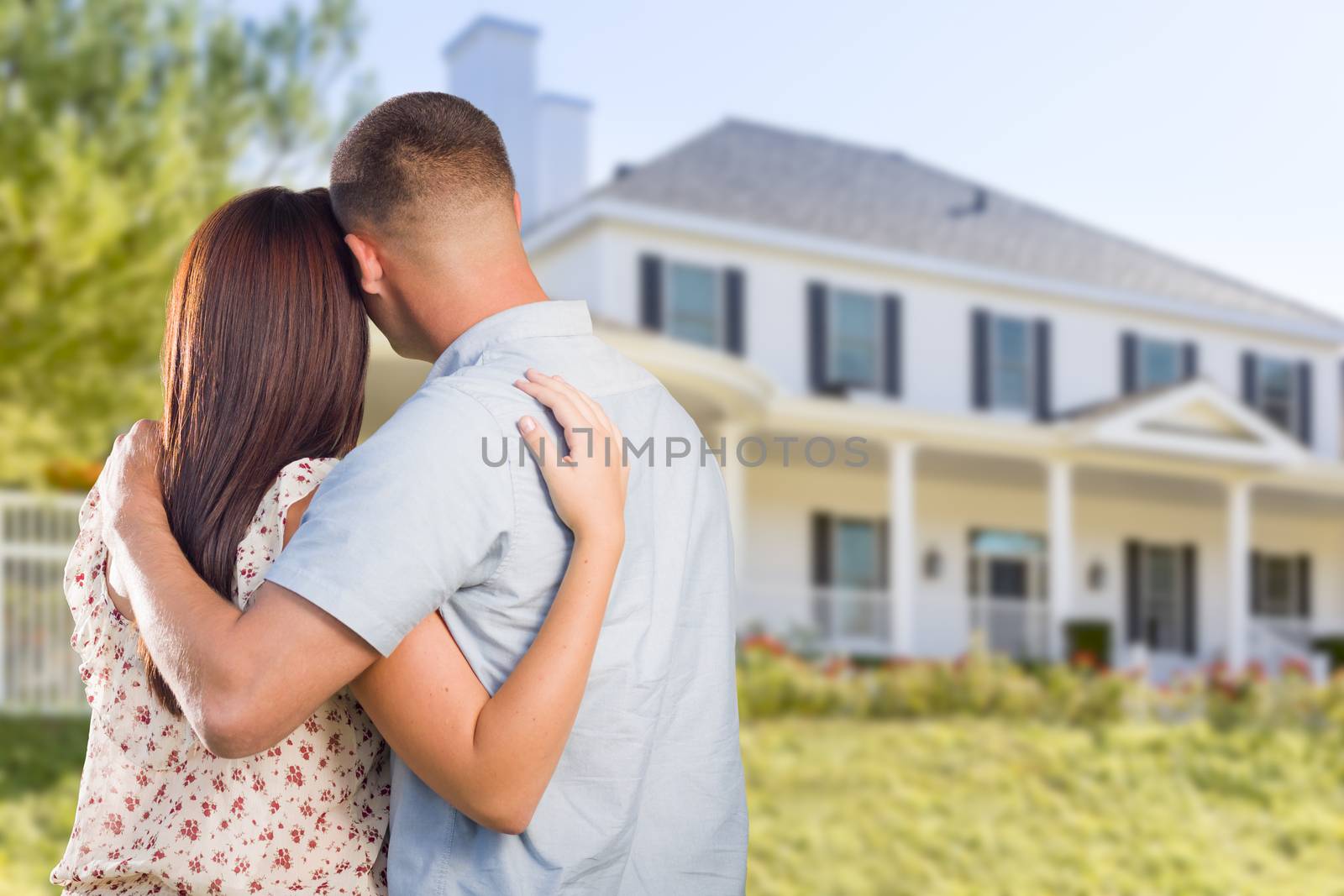 Affectionate Military Couple Looking at Nice New House.