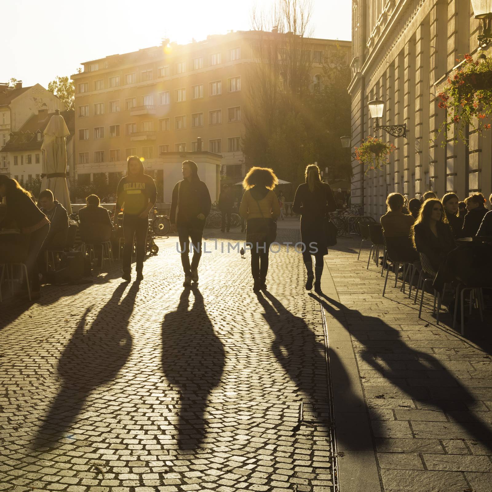 Ljubljana, Slovenia - October 30, 2014: People terracing (sitting, drinking coffee and people watching) in lively Ljubljana city center in the afternoon sun.