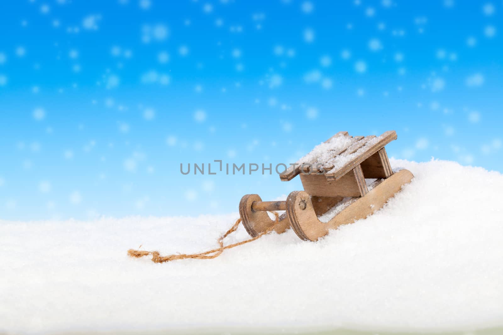 Old vintage wooden sled on blue background