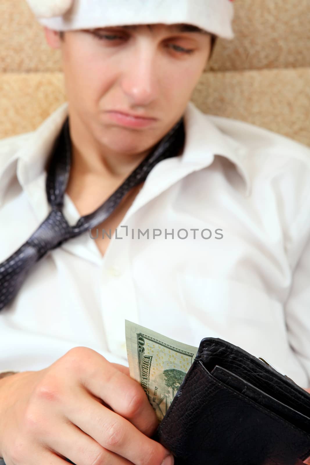 Teenager in Santa Hat Checking the Wallet on the Sofa at the Home