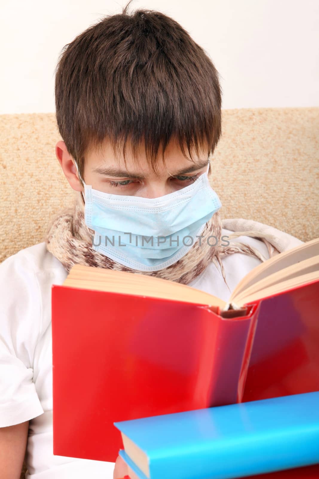Sick Teenager in Flu Mask with the Books on the Sofa