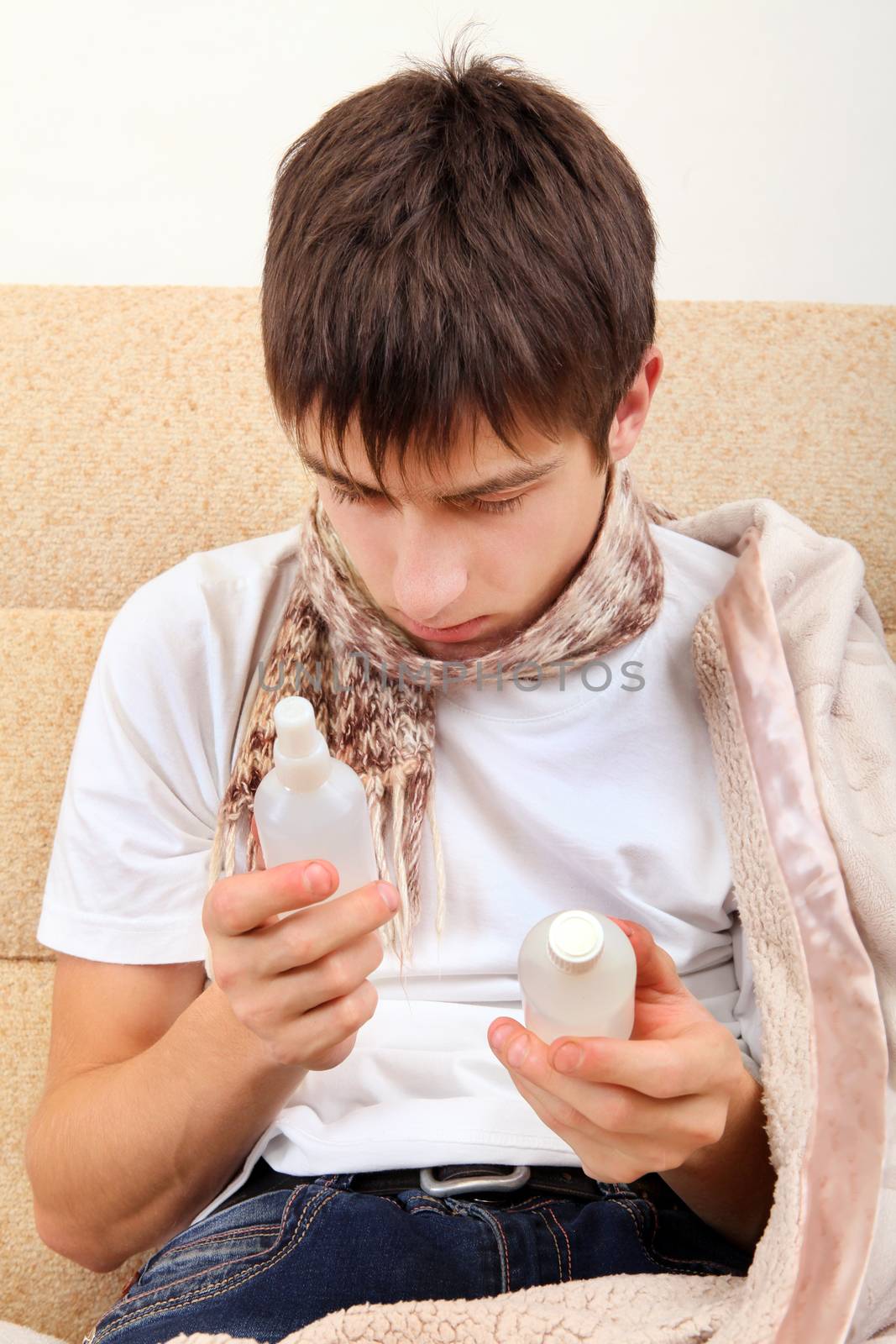 Sick Teenager choice the Medicine on the Sofa at the Home