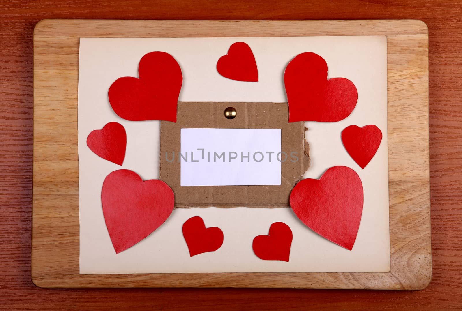 Notice Board with Heart Shapes on Wooden Background