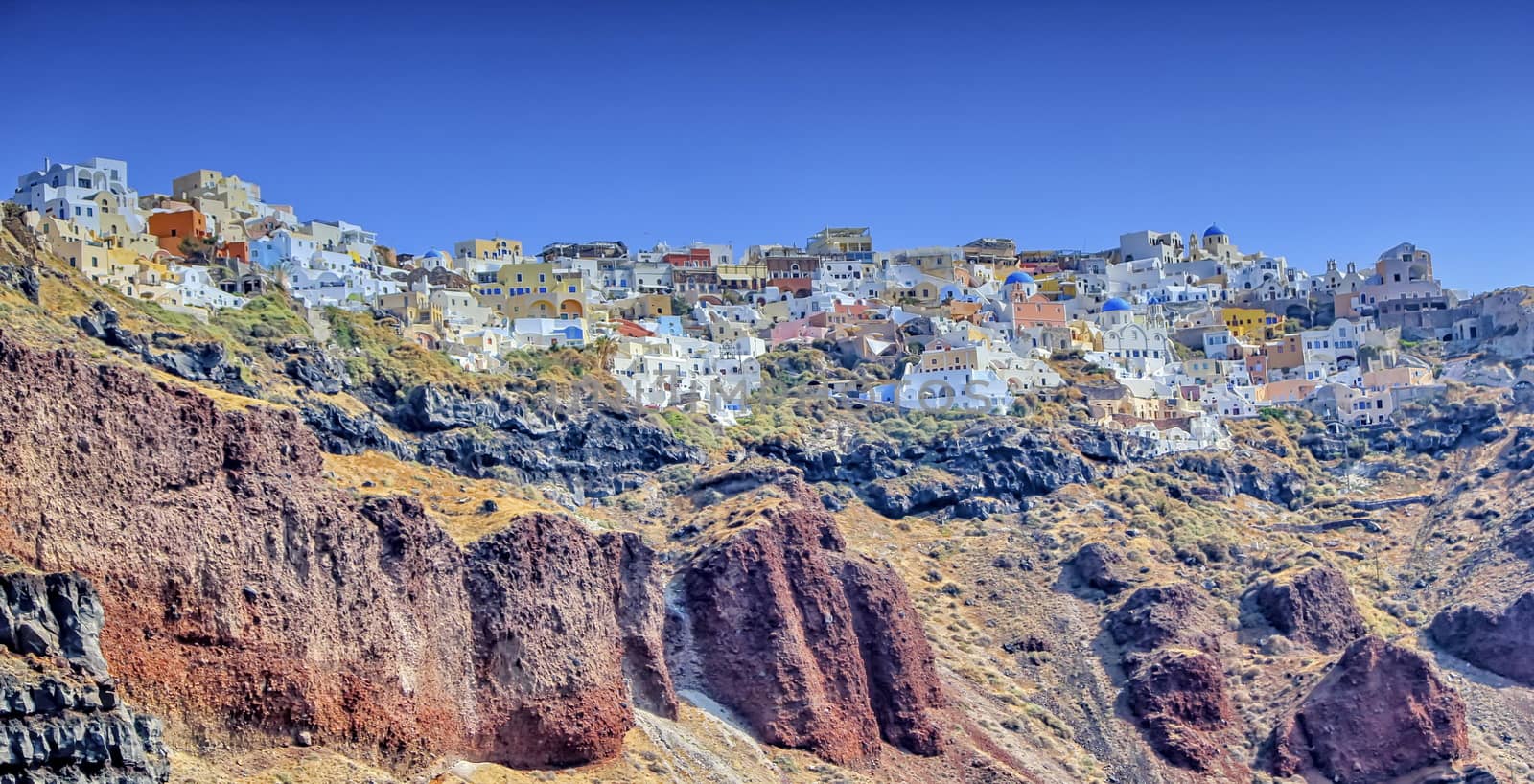 View of colorful Oia village on Santorini island by beautiful day, Greece