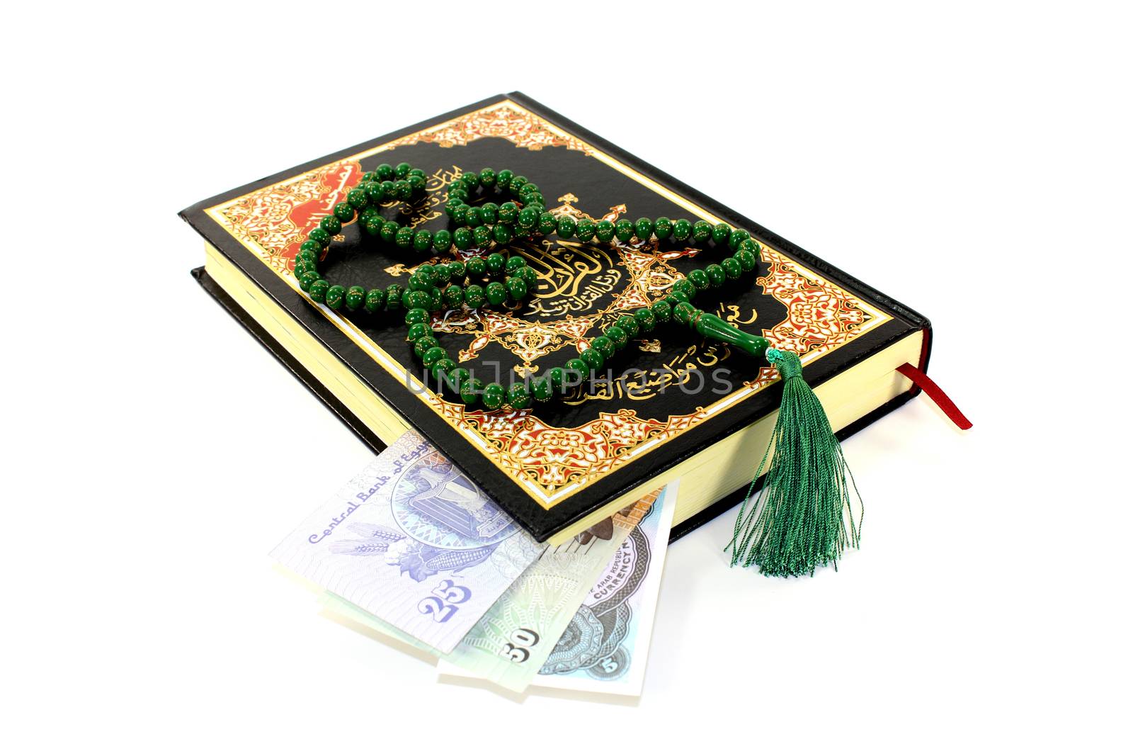 whipped Quran with Egyptian piastre before light background