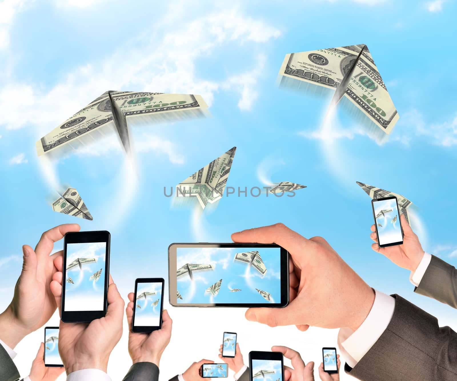 Hands holding smart phones and shoot video as flying paper plane of dollars by cherezoff