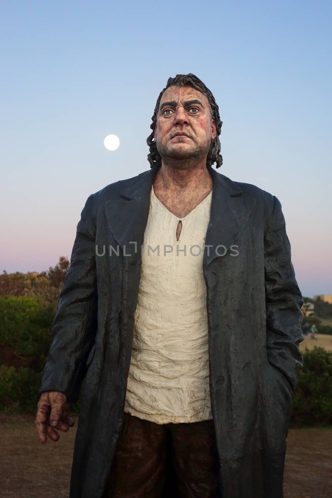 BONDI, AUSTRALIA -  NOVEMBER 9 , 2014; Closeup of sculpture  titled The Wanderer  by Sean Henry, England  at Dawn with Moon setting behind.
