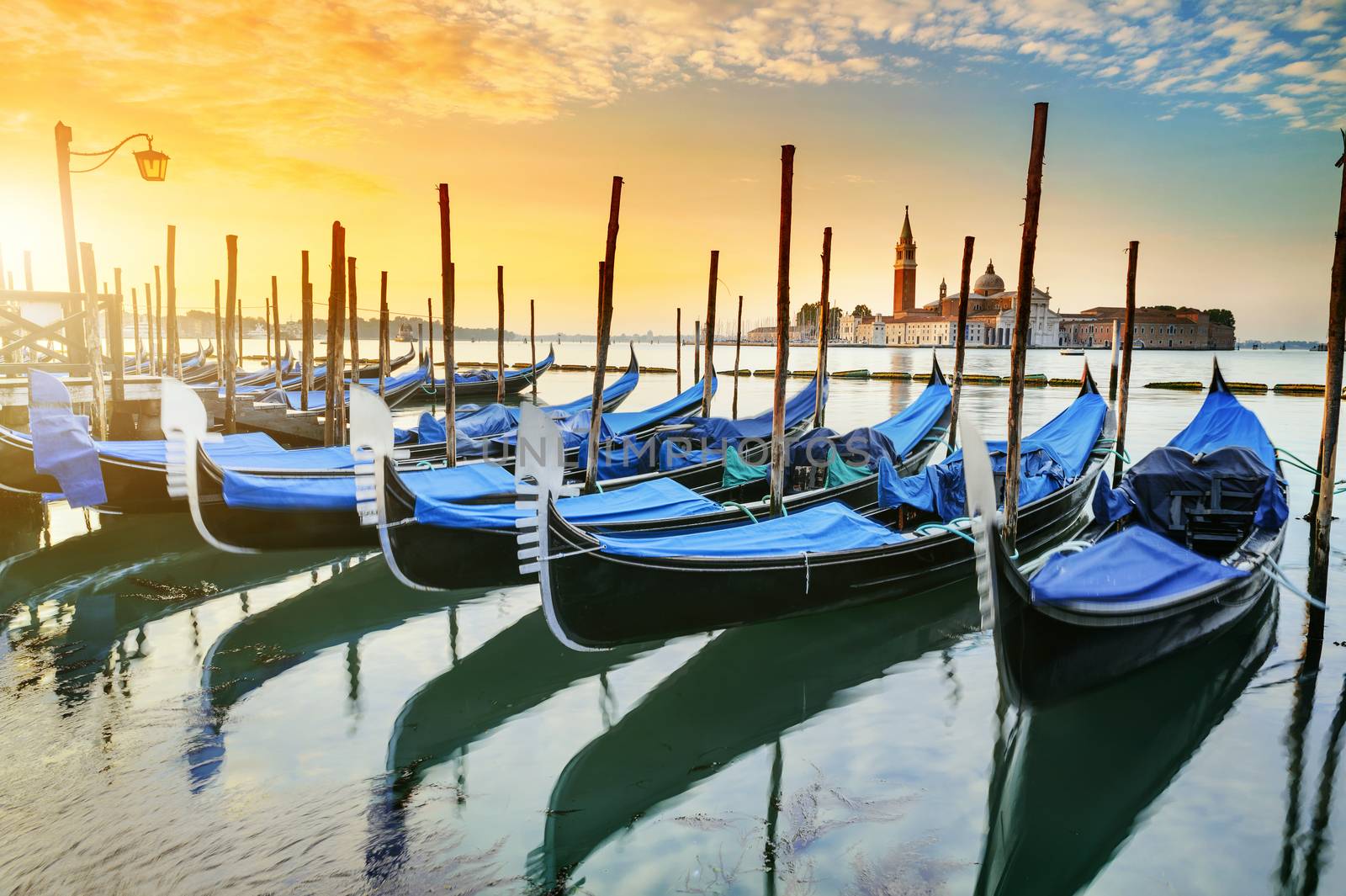 Gondolas moored by Saint Mark square with San Giorgio di Maggiore church in the background - Venice, Venezia, Italy, Europe 