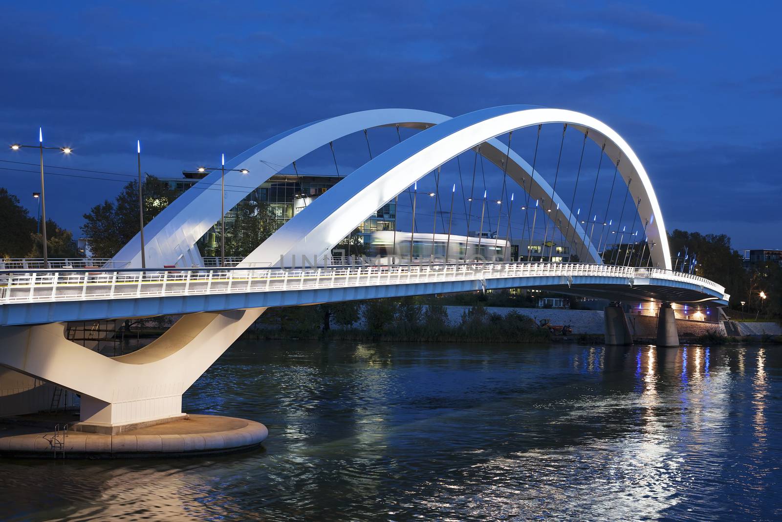 Tramway crossing the bridge at night, Lyon, France.