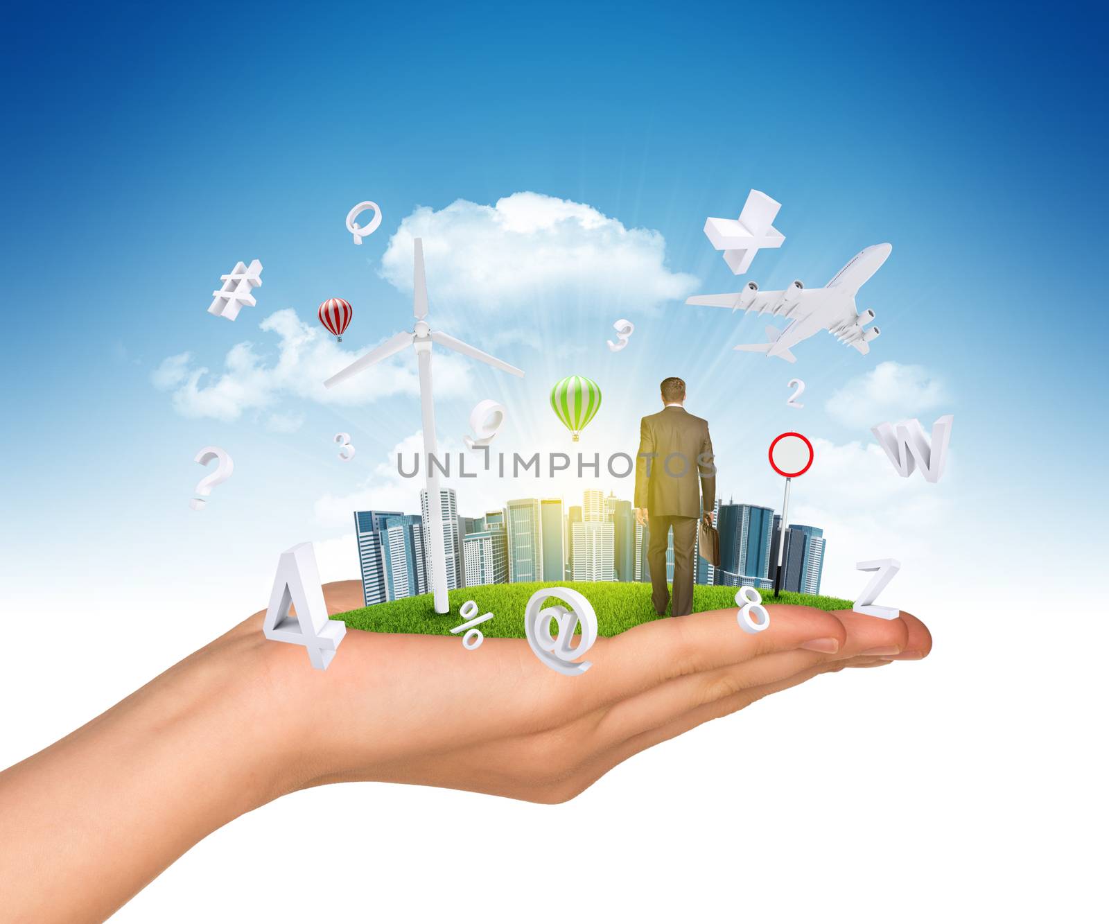 Hand holds city of skyscrapers on green grass and businessman walking forward. Flying letters near hand. Business concept