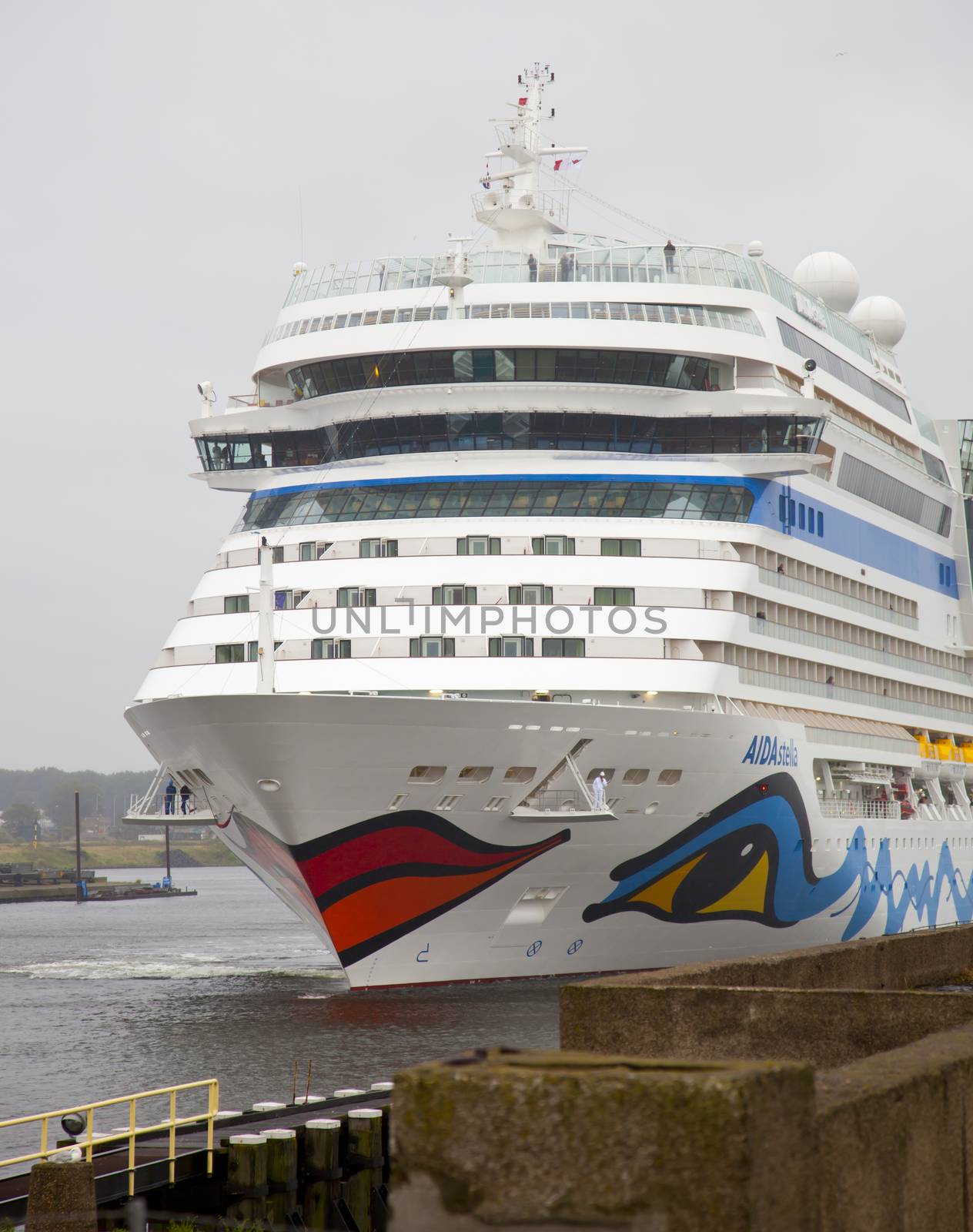 IJMUIDEN, THE NETHERLANDS - JULY 30, 2013: Cruise ship AIDA arrives at lock at IJmuiden, The Netherlands. Cruise ship AIDA is famous for the paintings of eyes and lips.