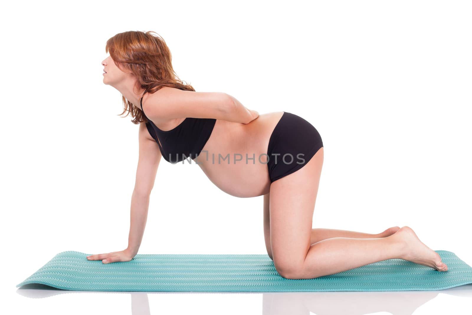 Pregnant woman doing yoga exercises. Isolated on white with wok path.