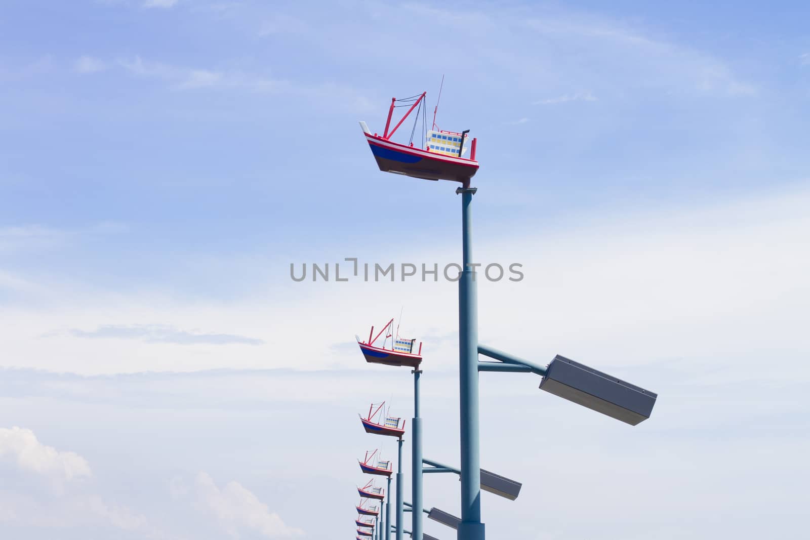 Lighting mast ship on a background of blue sky.