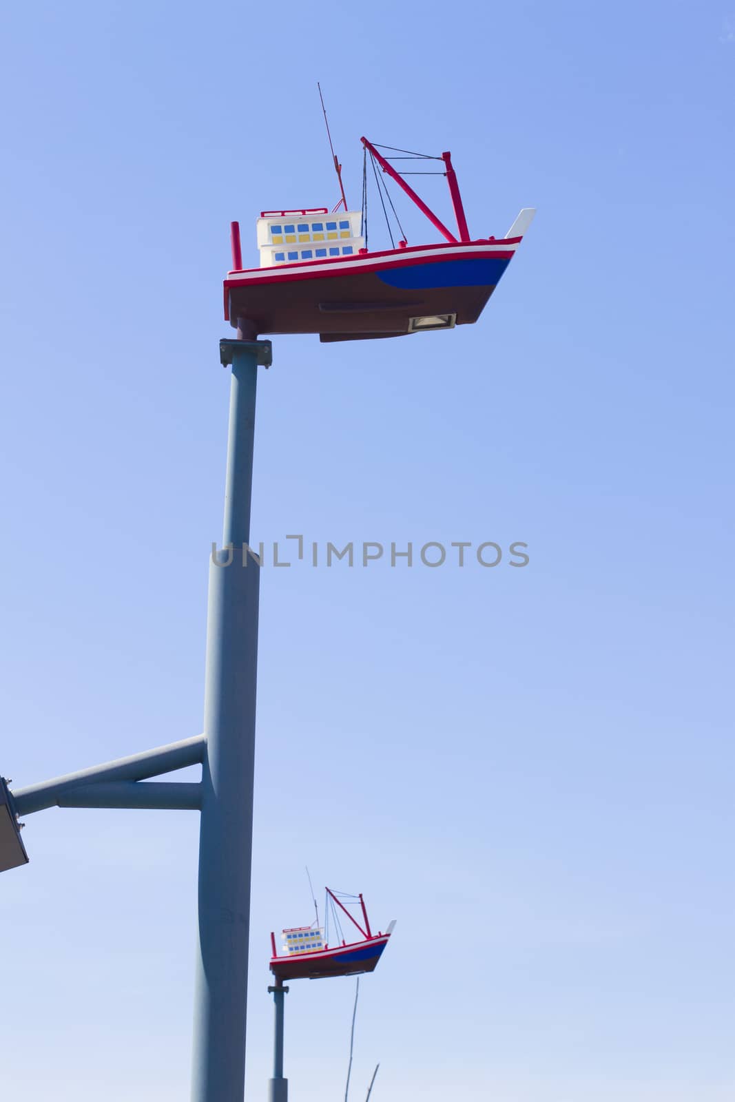 Lighting mast ship on a background of blue sky.