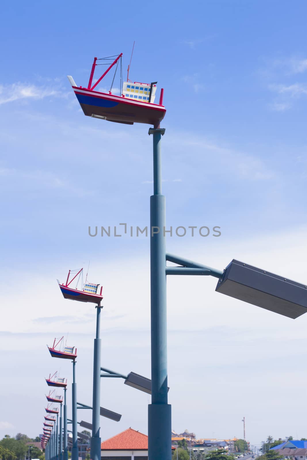 Lighting mast ship on a background of blue sky.