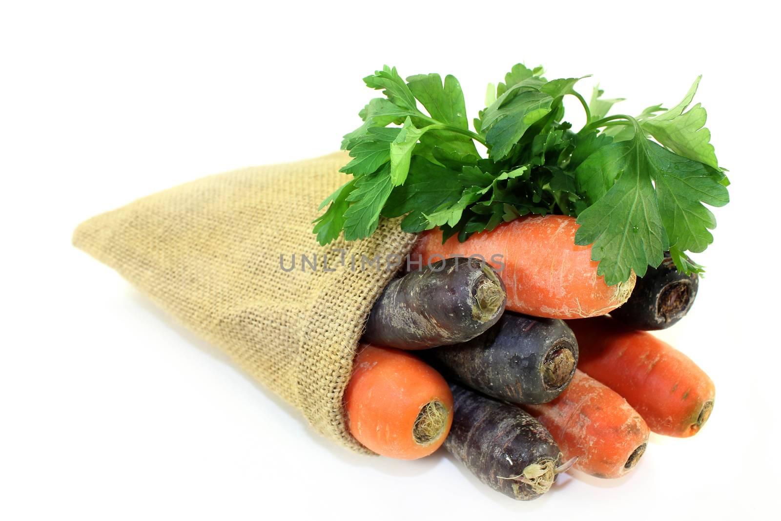 orange and purple carrots in a jute sack