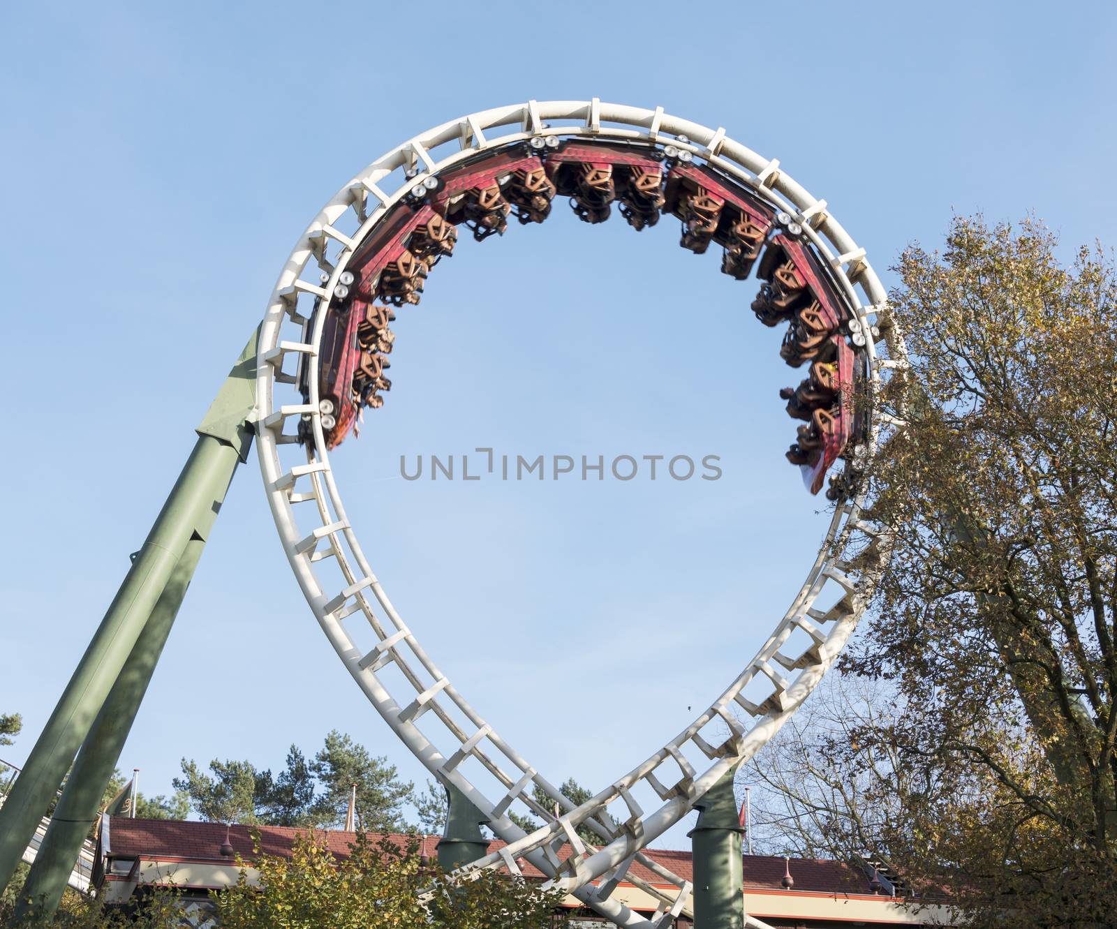 people in roller coaster on amusement park in holland