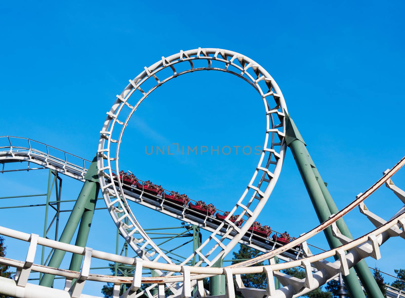 people in roller coaster on amusement park in holland