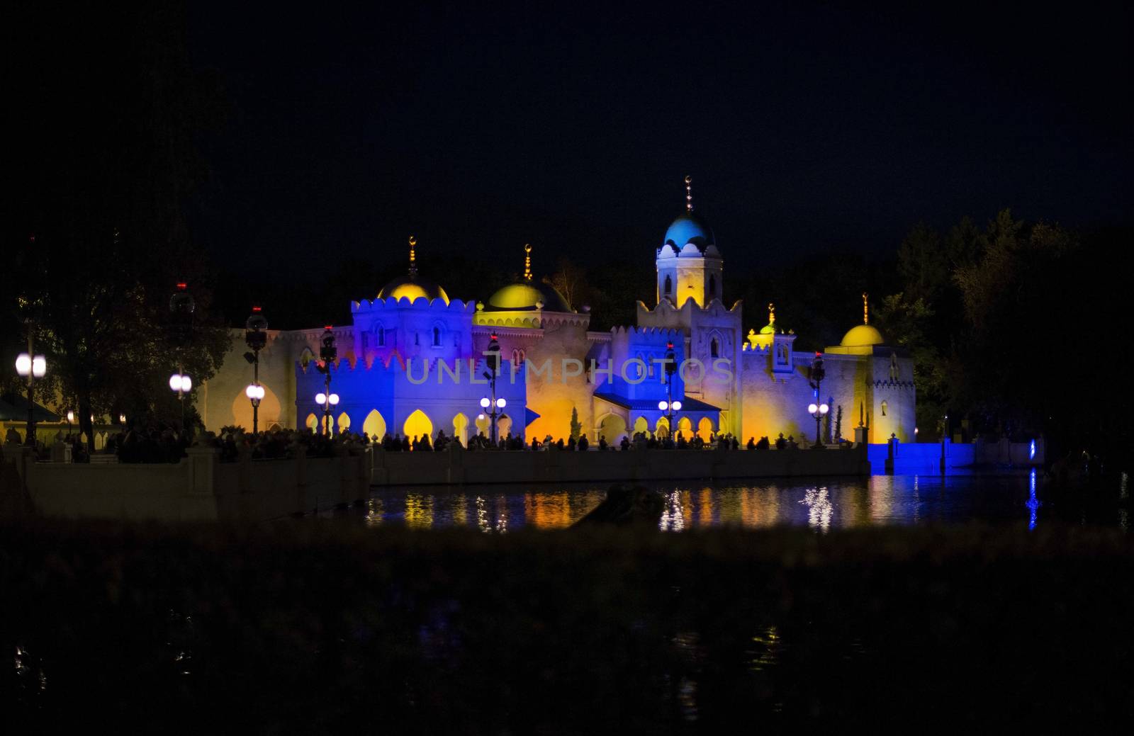 people at watershow in front of lightend castle at the amusement park in holland