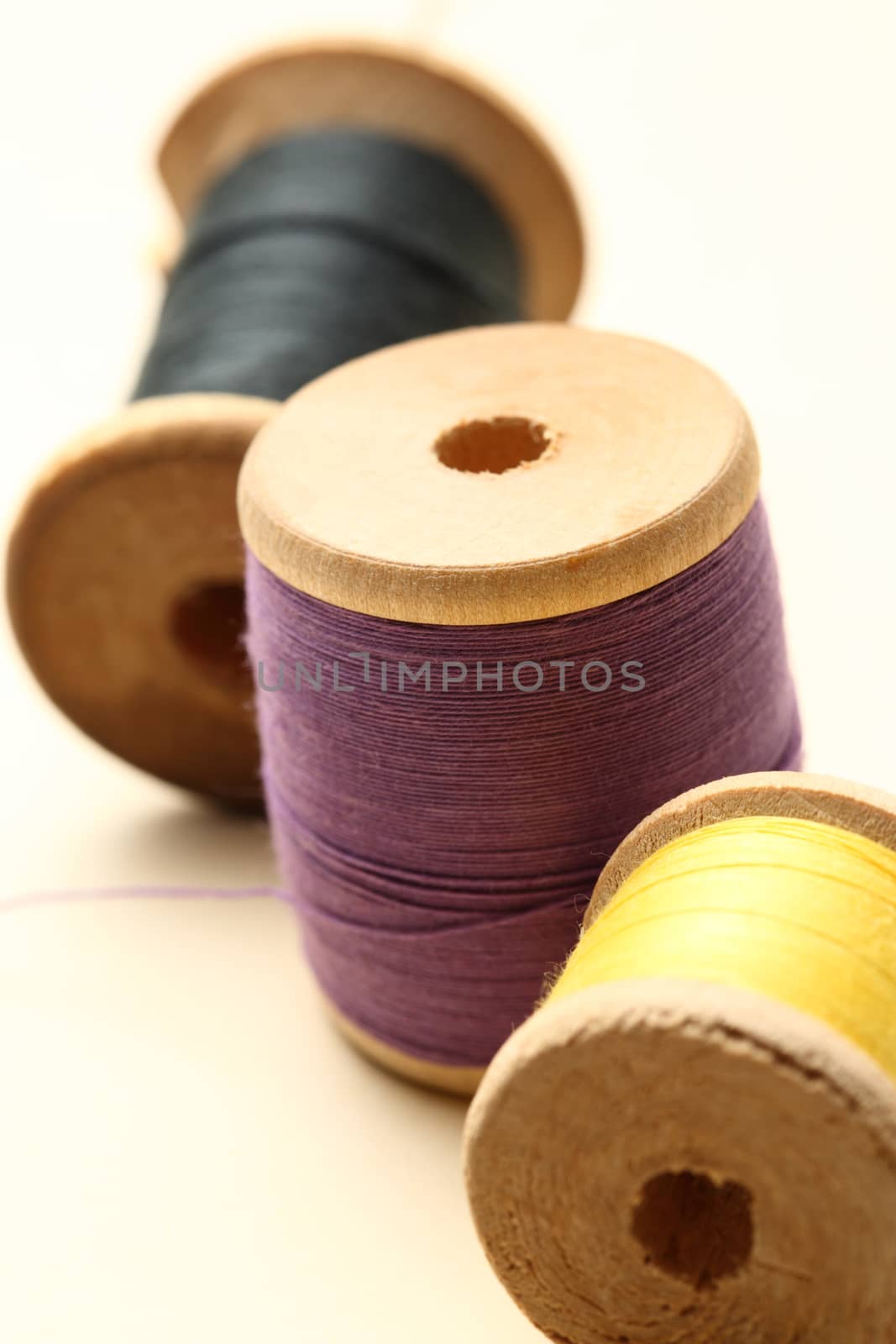 Three thread bobbins in closeup