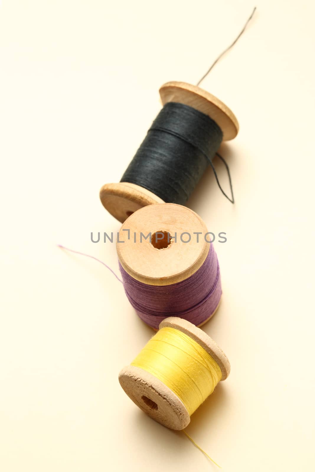 Three thread bobbins in closeup