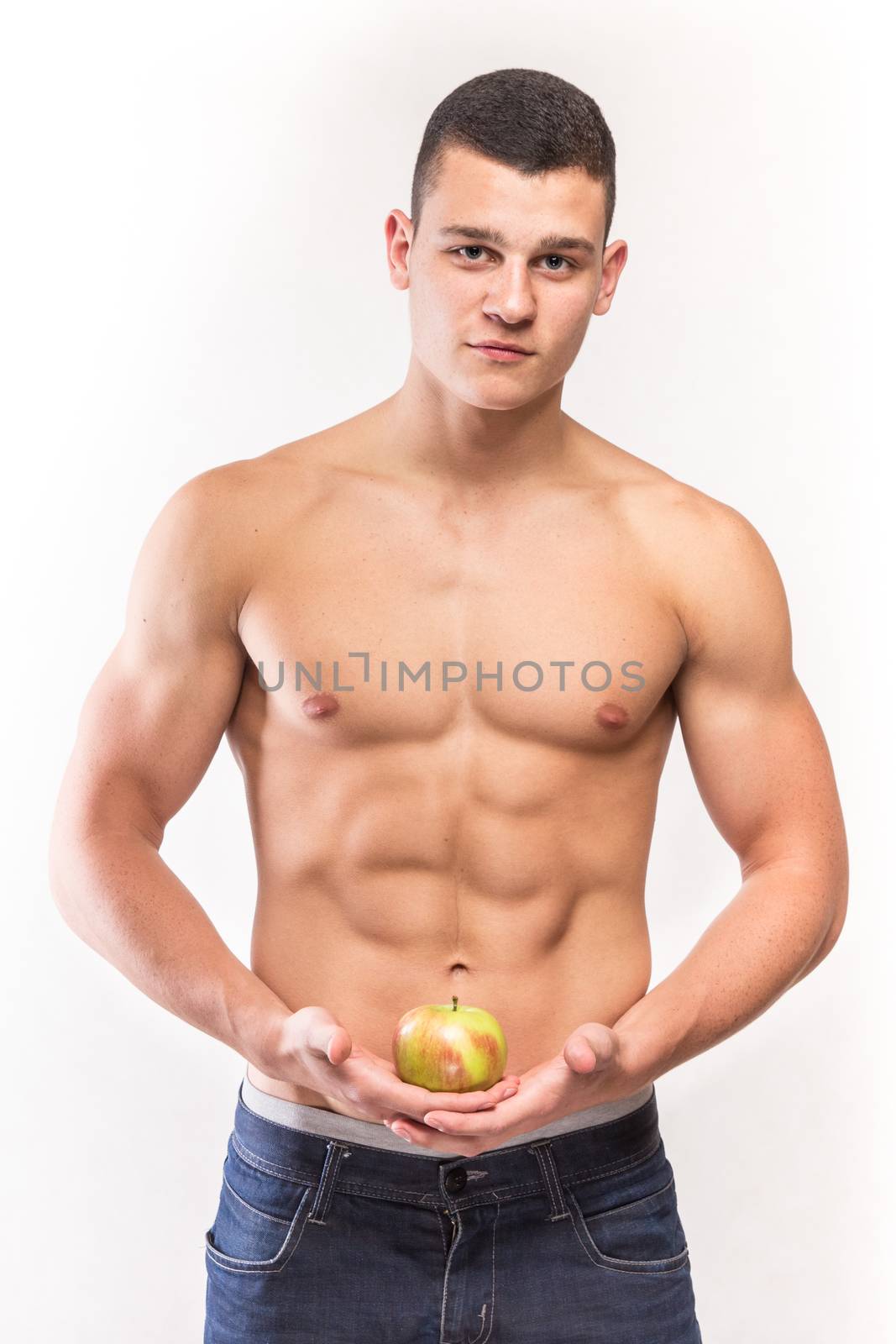 Fitness muscular man with apple - studio shoot 